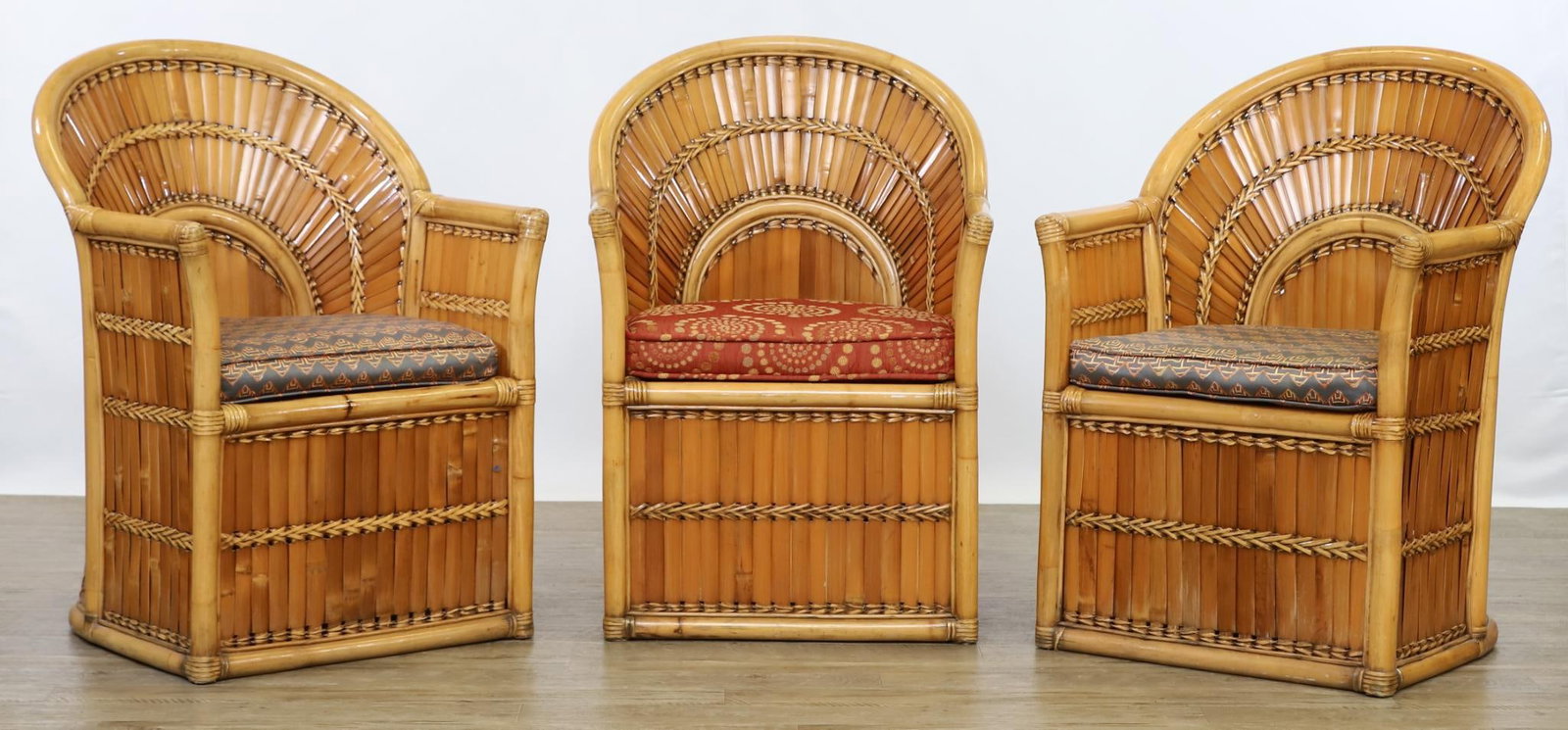Split Bamboo Patio Chairs: Patio lounge chairs made from woven split bamboo, the backs in a fan arrangement, with removable seat cushions. A set of (3). 34"h x 24"w x 23"d, seat height 17"h