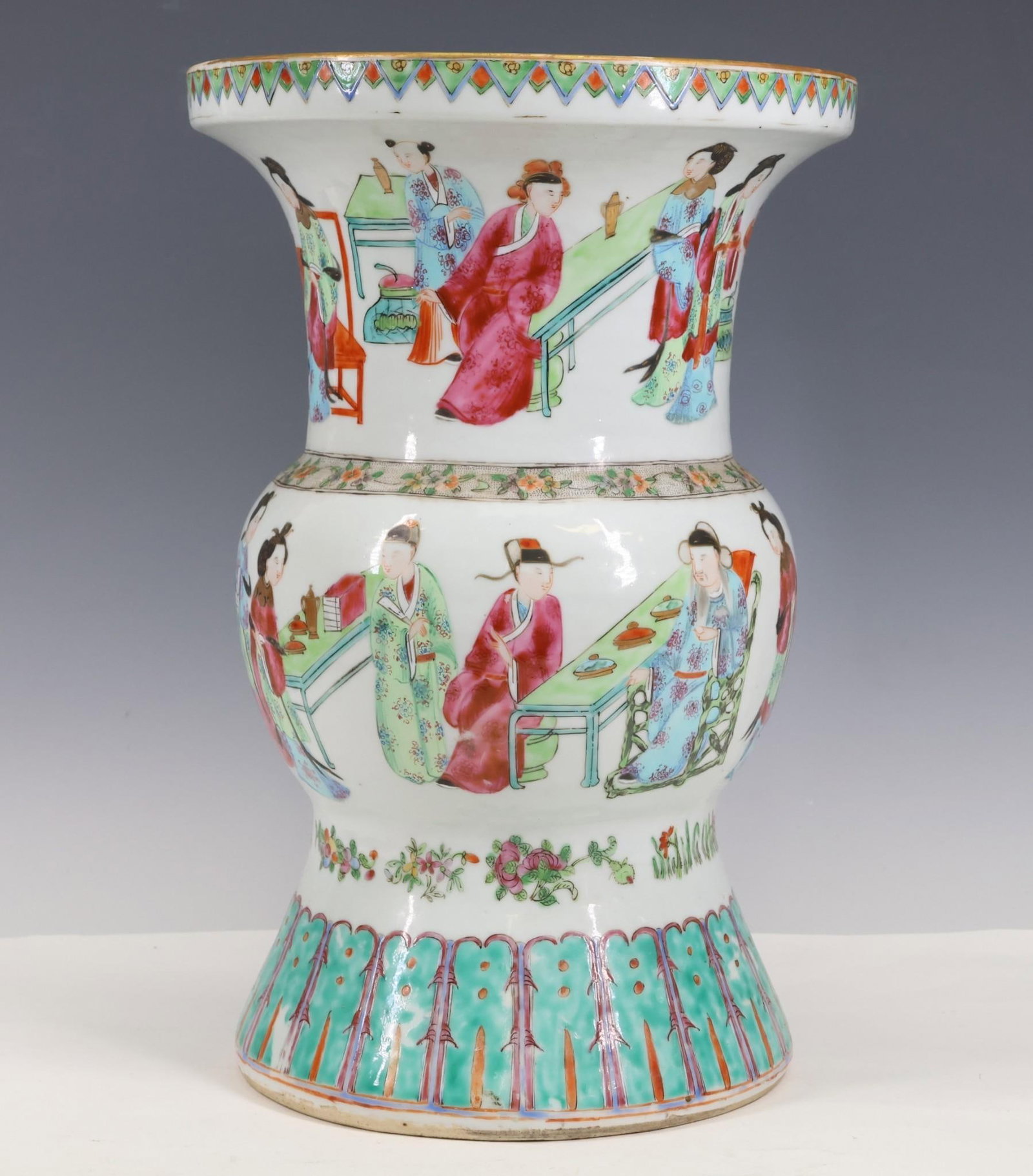 Chinese Famille Rose Beaker Vase: Qing era gu or beaker vase decorated with figures preparing and eating food, with lower ruyi border, upper geometric and rosette border, and floral bands. 13.25"h x 8.75"w