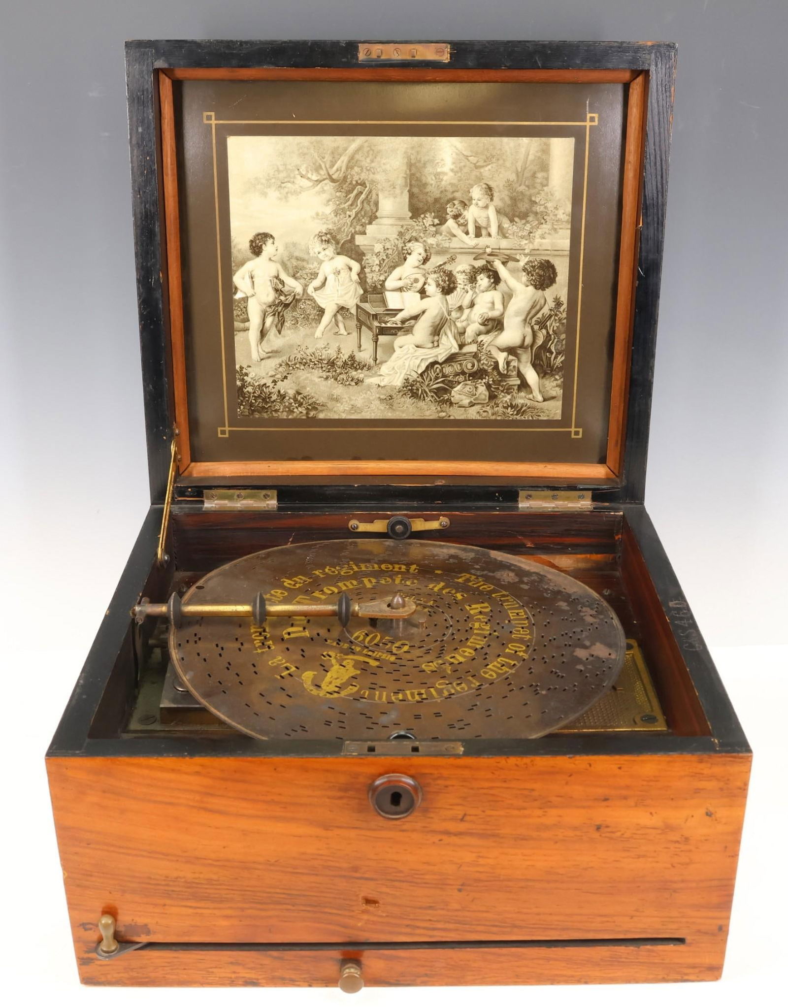 Polyphon Disc Music Box: Tabletop, single comb, 9.5" disc music player with crank, in an oak case with bone inlay and interior rosewood panels. Winds and plays, but the start/stop lever does not function; some loss and dings