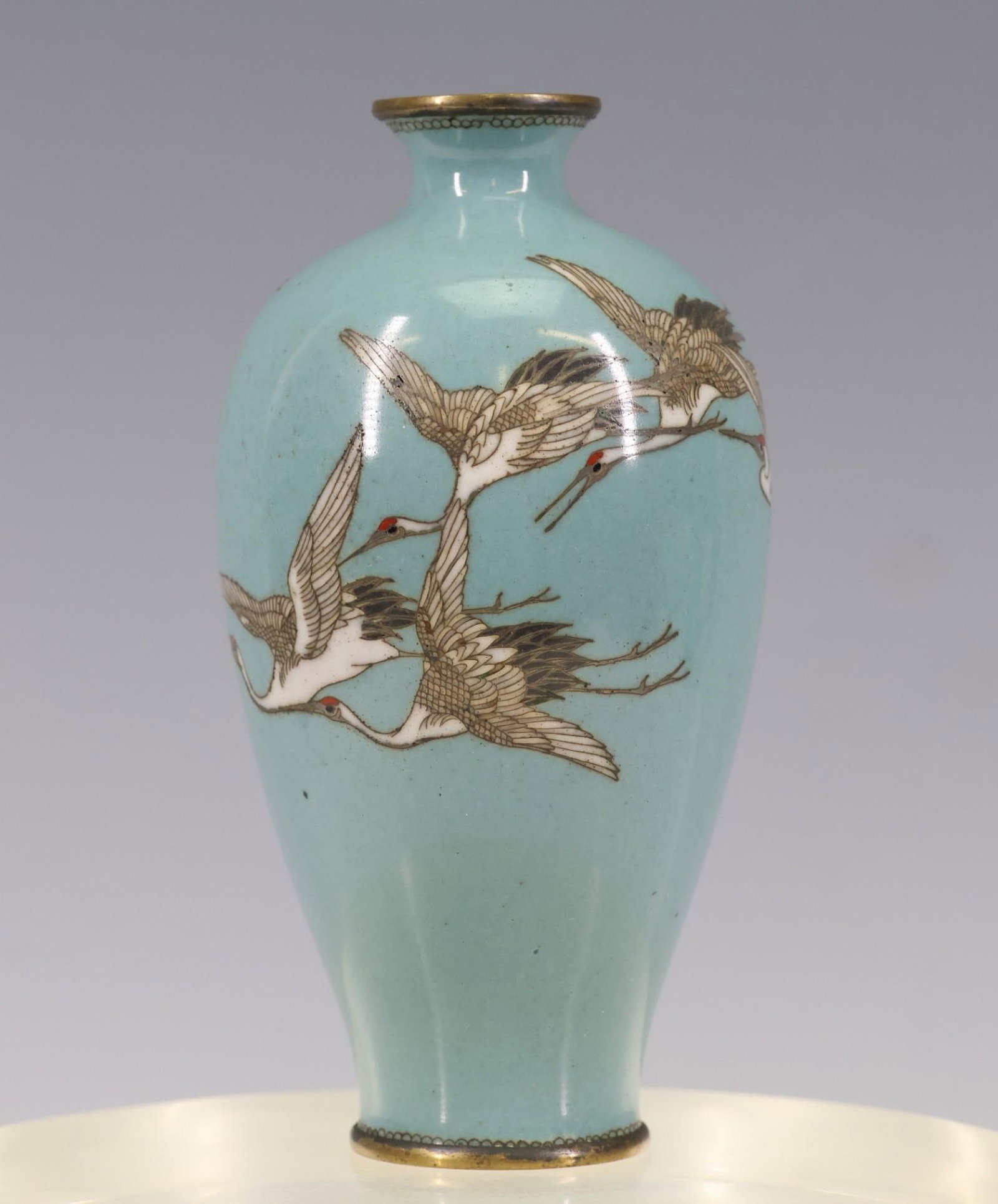 Japanese Cloisonne Miniature Vase: Meiji - Taisho era miniature vase depicting cranes in flight on a sky blue ground. 3.75"h x 2"w