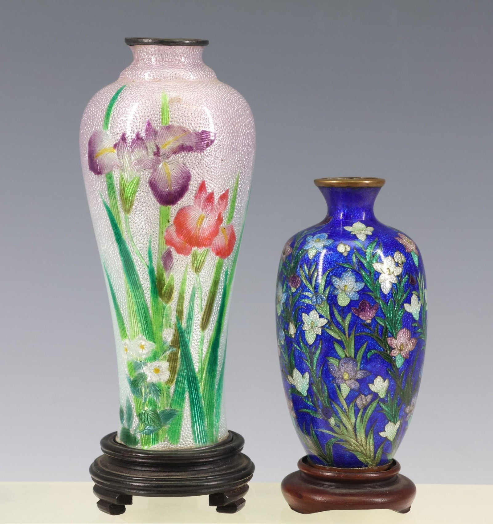 Japanese Ginbari Tsuiki-Jippo and Cloisonne Vases: Meiji - Taisho era vases, tsuiki-jippo textured orchids on a pink ginbari ground, and a cloisonne garden of flowers on a cobalt blue ginbari ground. 5"h x 2"w and 3.5"h x 1.75"w. Hairlines and small p