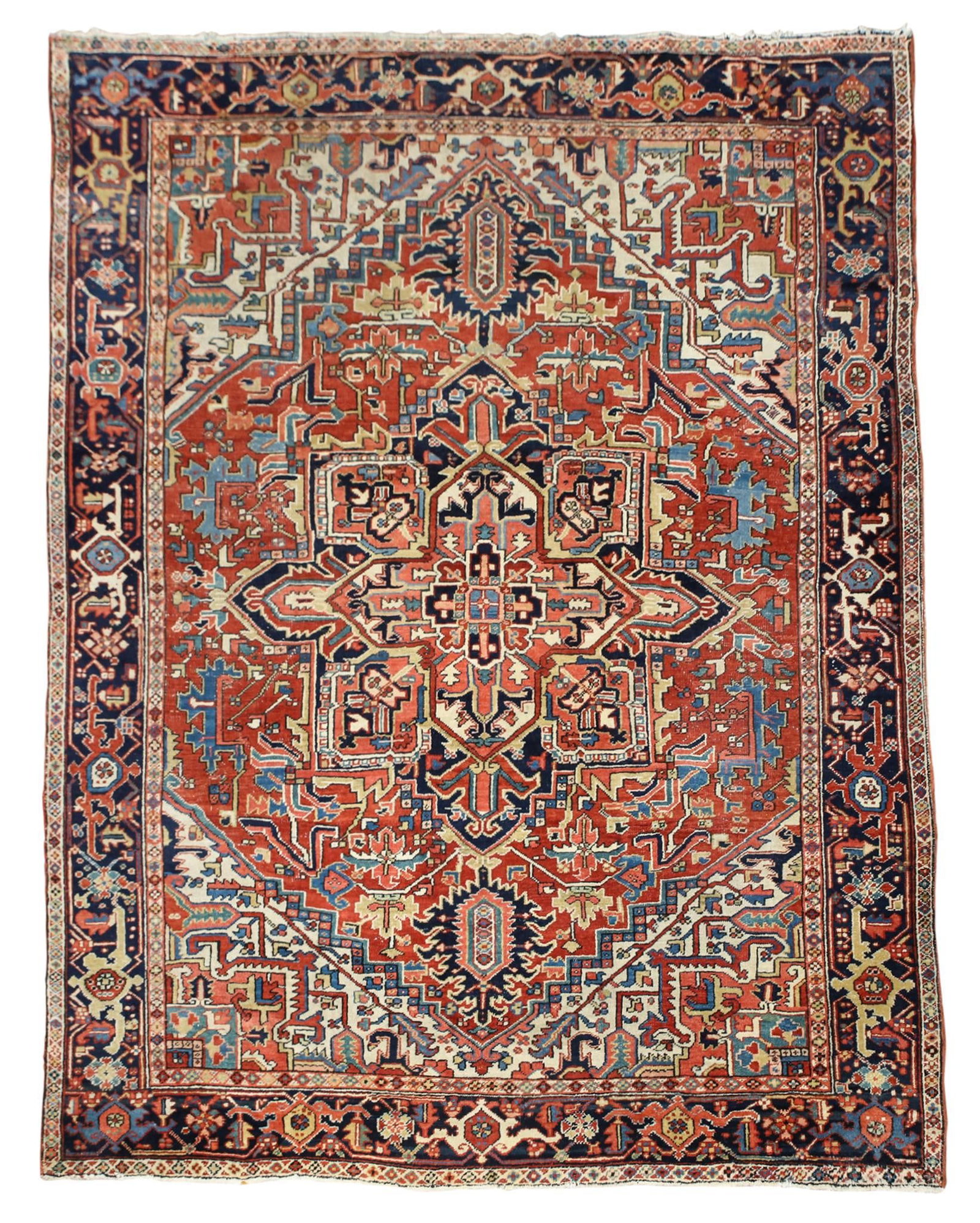 Persian Heriz Rug: Hand knotted, geometric central medallion with pendants, all-over arabesque and rectilinear filed motifs, with repeating cartouches in the main border. Polychromatic colors of red, Light and navy blue
