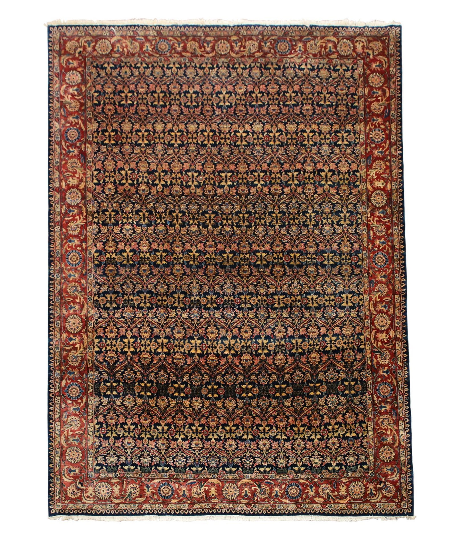 Indian Agra Rug: Hand knotted with repeating floral and foliate designs in a blue field with a repeating floral cartouche, vine scroll, and red main border. Rug exhibits a faded area near the center of the rug. Early 