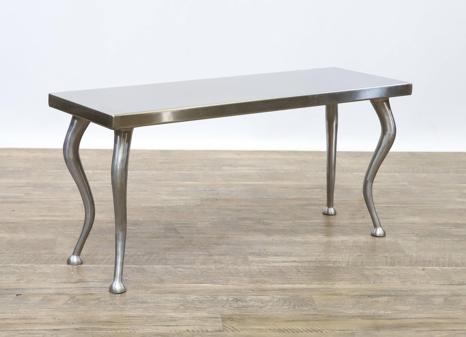 Aluminum Bench: Industrial bench featuring a aluminum clad wooden seat with stylized cabriole legs. 17"h x 36"w x 12"d