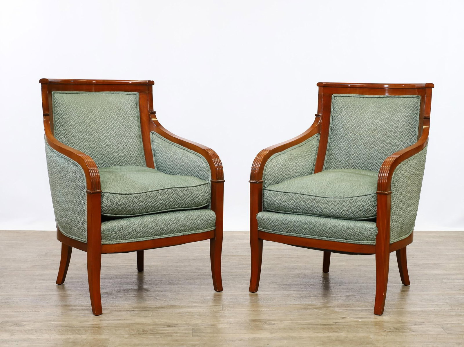 Hickory Accent Armchairs: Mahogany bergere style pair of accent chairs, with curvilinear backs, fluted arms, tapered square saber legs, and textured teal upholstery with removable seat cushions, unmarked. Wear to the upholster