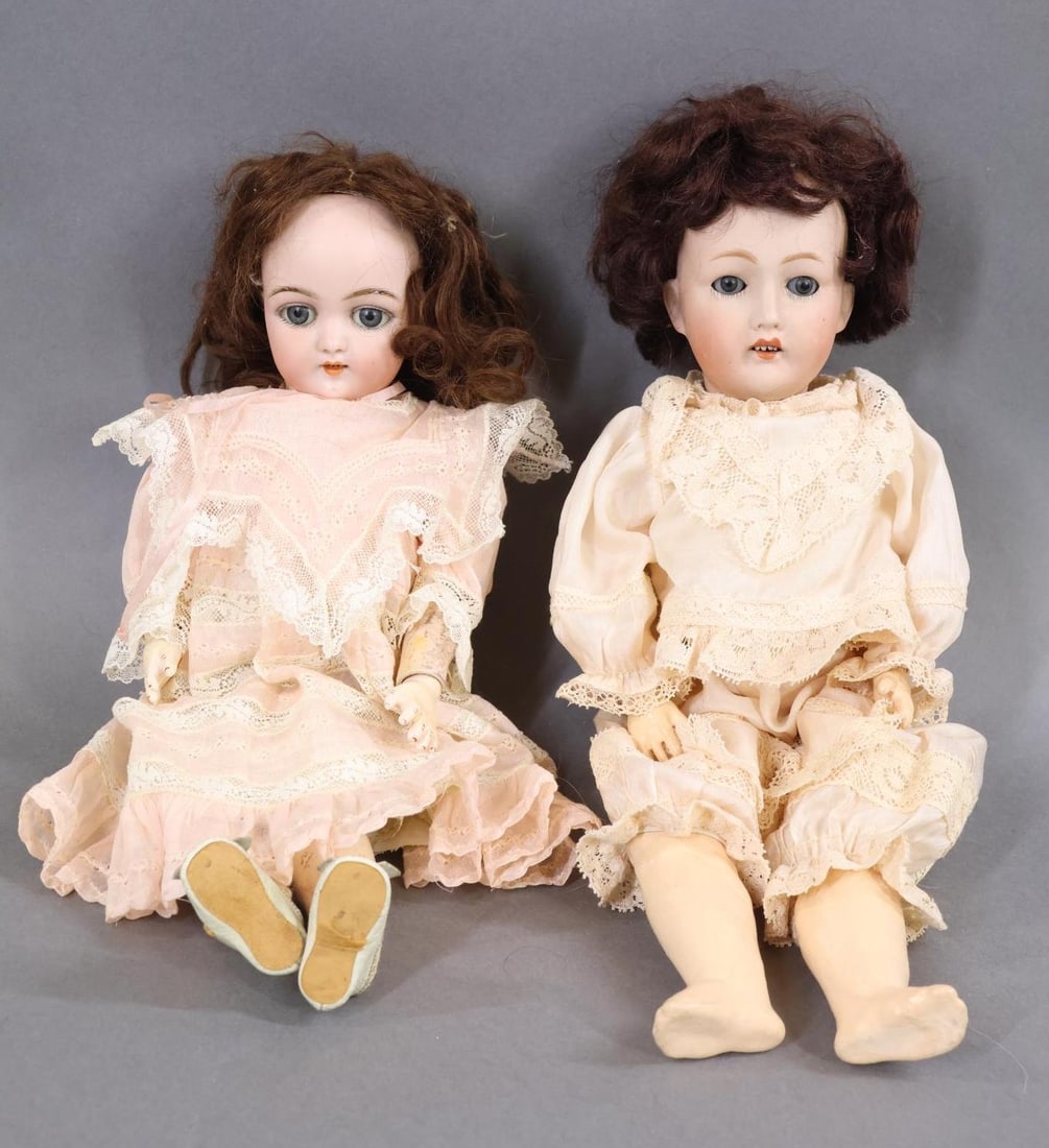 GERMAN BISQUE DOLLS.: Pair of GERMAN dolls. Both dolls have sleep eyes, open mouths, dark brown mohair wigs, papier mache ball jointed bodies. Doll 1) 12" SH 1079 - 4 DEP GERMANY with pierced ears. Dressed in antique under