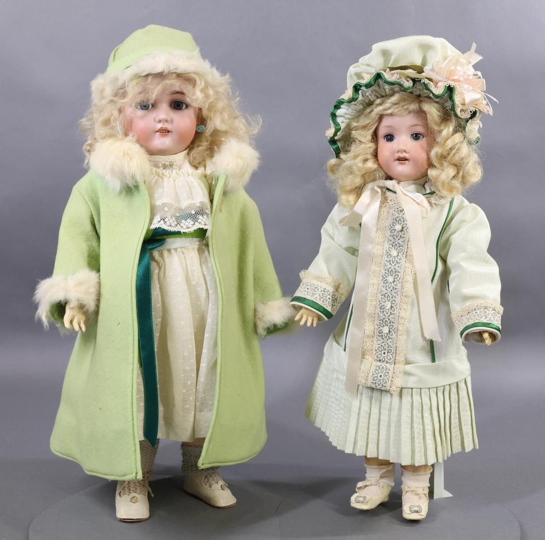 GERMAN BISQUE DOLLS.: Pair of GERMAN dolls. Both dolls have blue sleep eyes, open mouths, blonde wigs, papier mache ball jointed bodies. Doll 1) 19" 1349 "JUTTA" S & H 8 1/2" doll with curly mohair wig, pierced ears. Dress