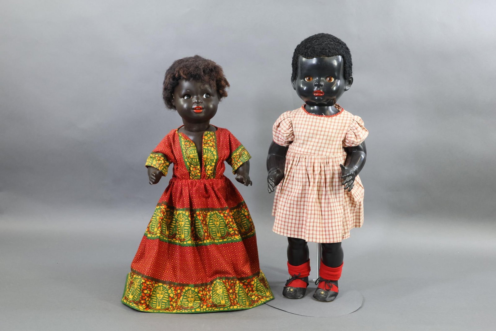 BLACK DOLLS.: Pair of dolls. Both of them have sleep eyes, short black wooly wigs, 5 pc. toddler style bodies. Doll 1) is HP and marked MADE IN ENGLAND. She is a walking doll, has a closed mouth. 1 Pc. outfit may b