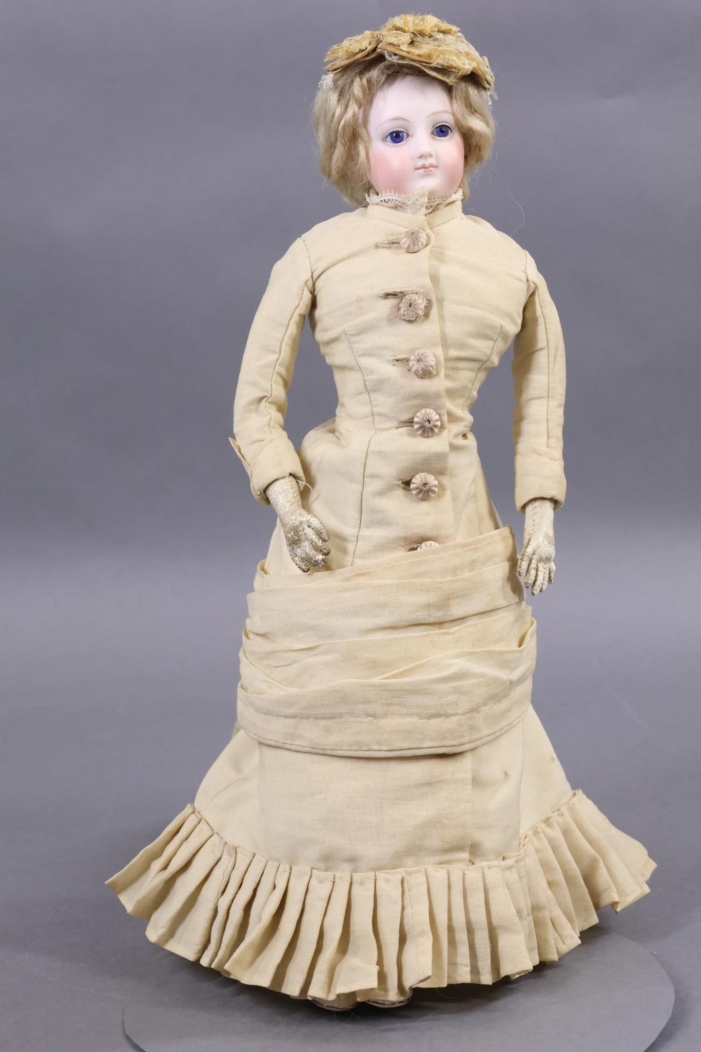 FRENCH FASHION DOLL.: 15" "2" Doll with blue eyes, closed mouth with lips outlined in red. Pierced ears, blonde mohair wig, cork pate. Swivel neck on an unmarked bisque shoulder plate. Face is a little different from other