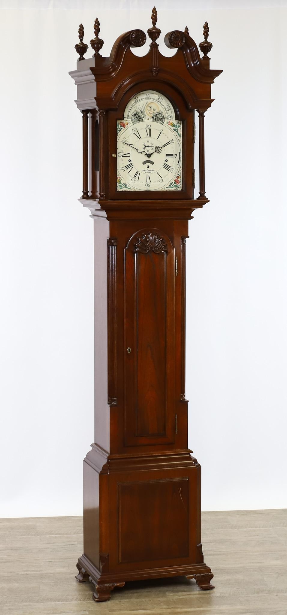 John Goddard Sligh Tall Case Clock: Cherry case, broken arch pediment with flamed finials, arched shell carved waist door flanked by reeded colunms, plinth base with ogee bracket feet. 8-day works with painted moon phase dial. Clock is