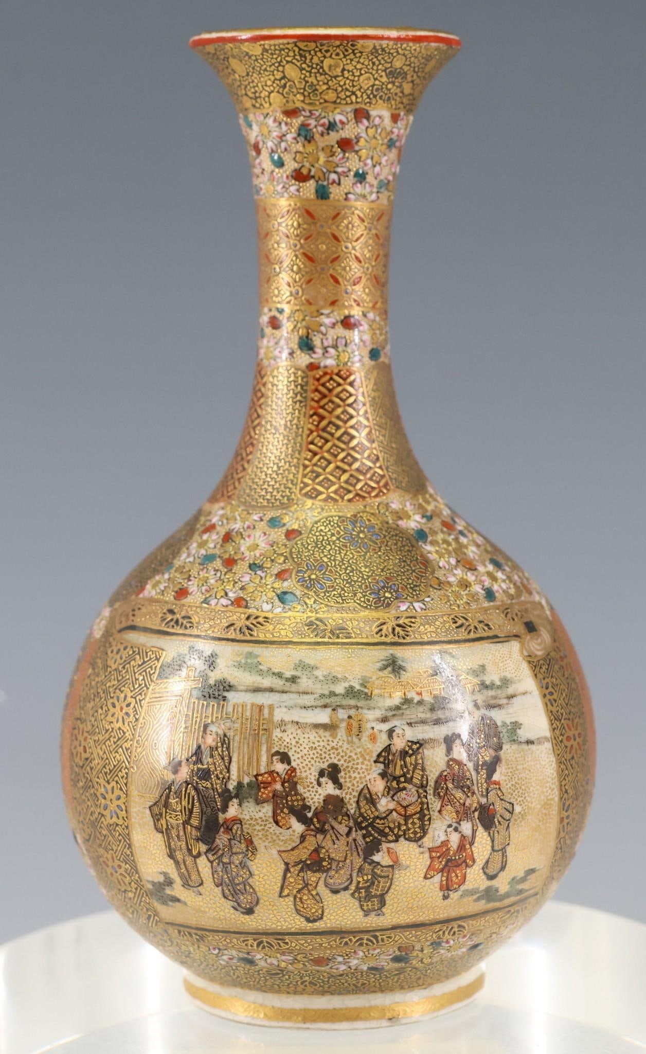 Hattori Japanese Satsuma Pottery Vase: Meiji - Taisho era bottle vase with panels on each side depicting figures, most likely actors preparing for the stage, surrounded by moriage enamel and gold floral and geometric decoration. 4.75"h x 2