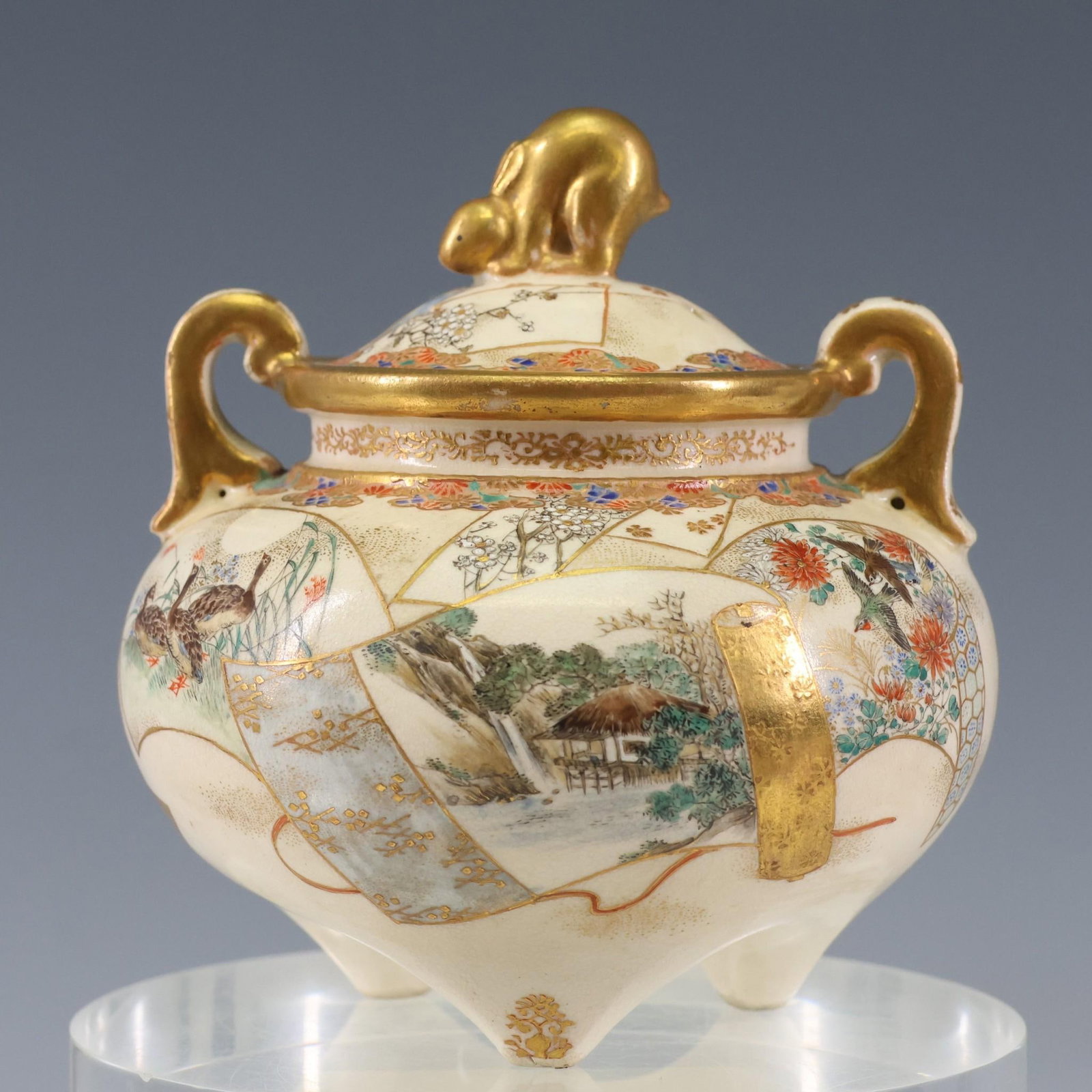 Japanese Satsuma Pottery Censer: Meiji - Showa era censer with tripod feet, handles, and a pierced cover with rabbit form finial, decorated with scroll form panels depicting landscapes, birds, and flowers. Unmarked. 3.75"h x 3.5"w
