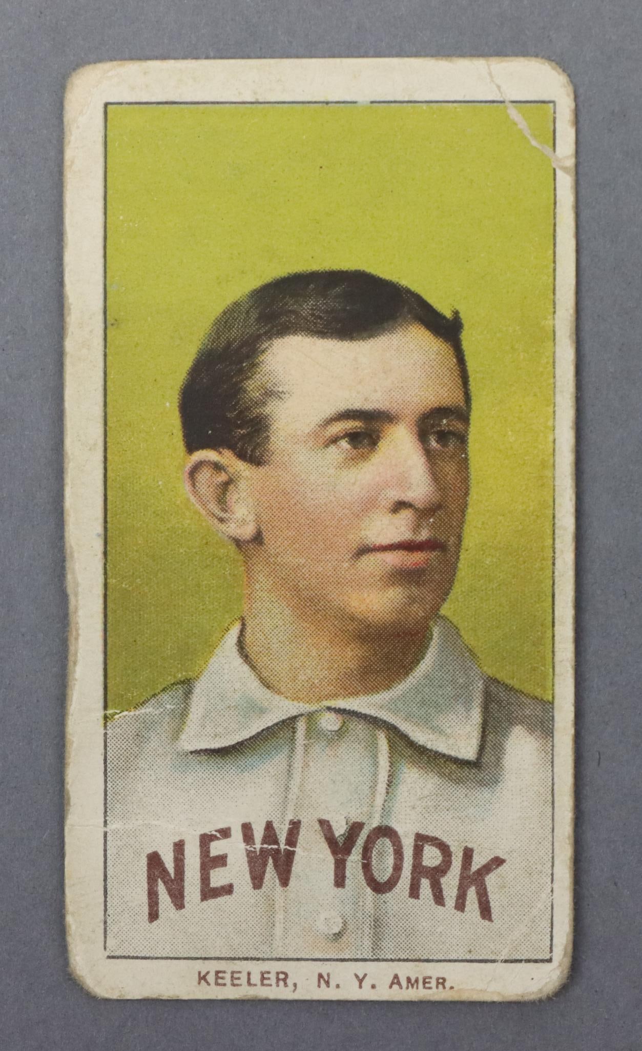 1909-11 T206 Piedmont Willie KeelerBaseball Tobacco Card: 1909-11 T206 Piedmont White Border "Wee" Willie Keeler HOF baseball tobacco card (portrait variation). The card has creases on the top & bottom right hand corners and across his chest at "New York." T