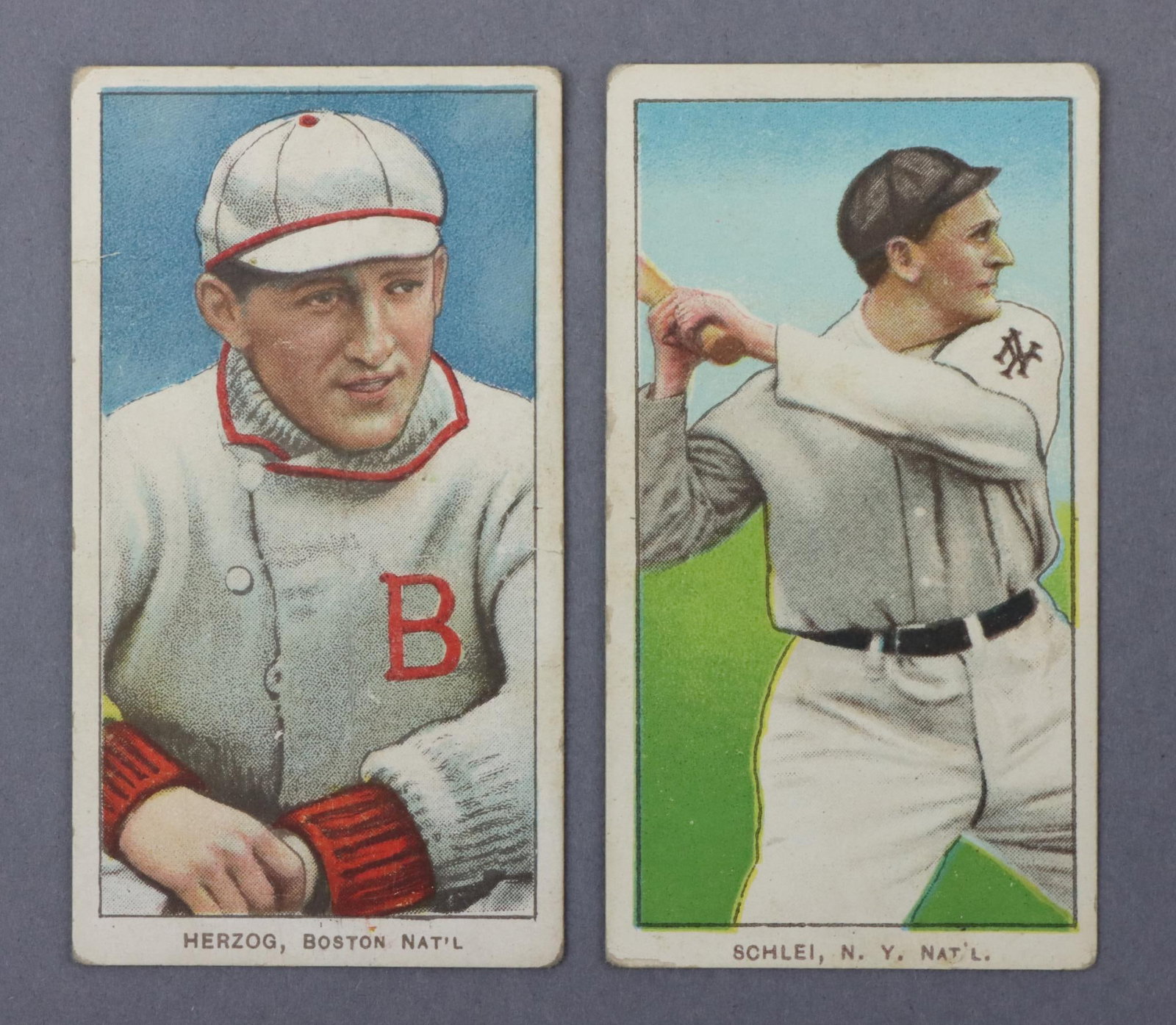 (2) 1909-11 T206 Piedmont Baseball Tobacco Cards: (2) 1909-11 T206 Piedmont White Border baseball tobacco cards: Buck Herzog (Boston variation) & Admiral Schlei (batting variation). The cards are free of creases. Both cards feature a Piedmont 350-460