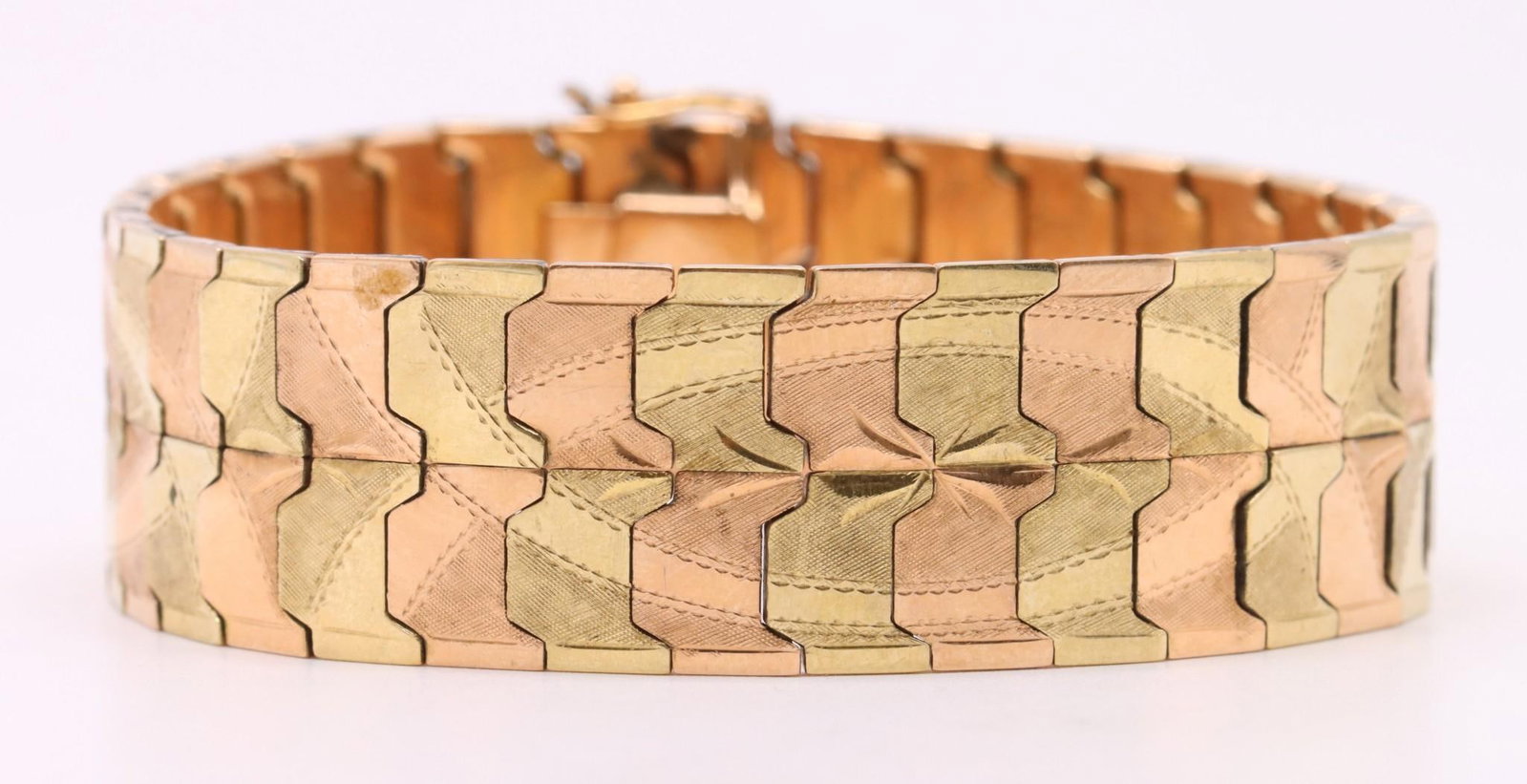 14k Gold Bracelet: 14k yellow and rose gold bracelet with chased decoration. .75" wide and 7.25", and 21.2dwt