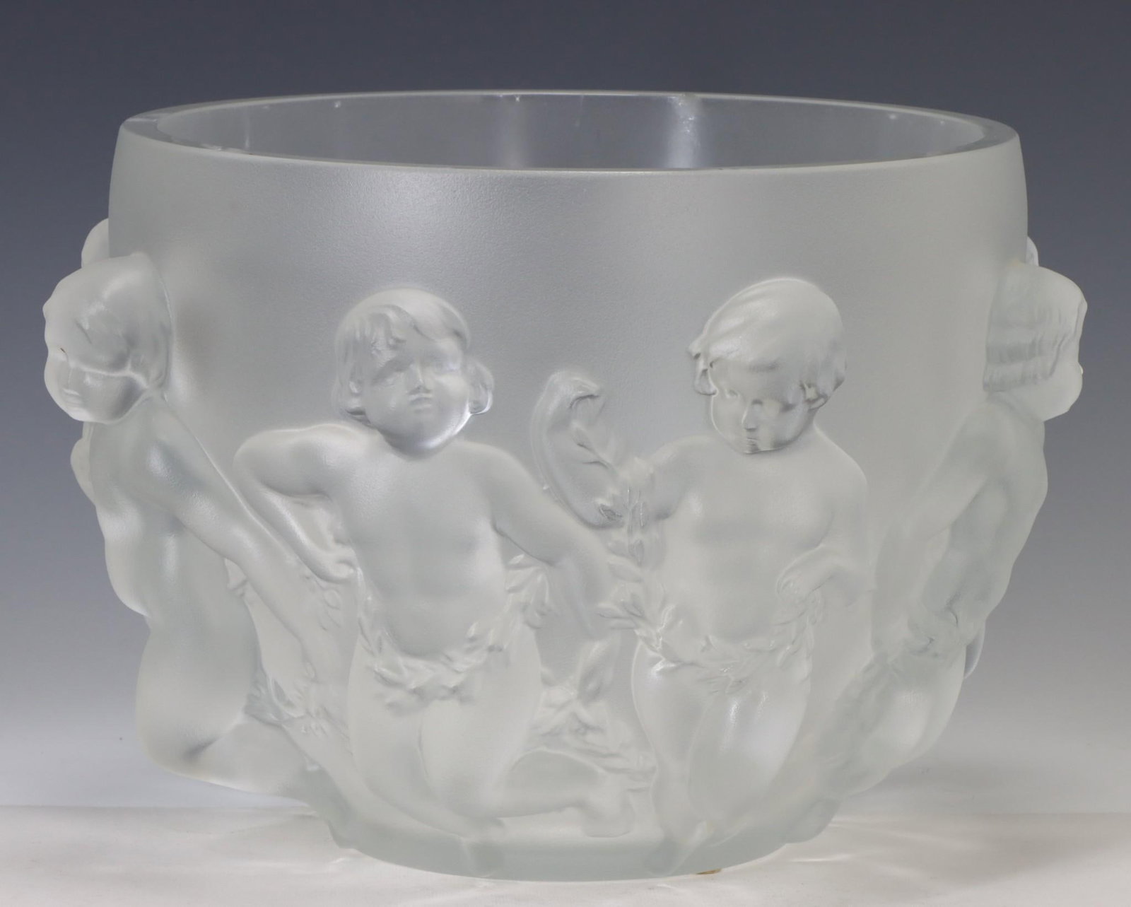 Lalique Luxembourg Crystal Centerpiece Bowl: French molded crystal centerpiece bowl, frosted with dancing putti in relief, with engraved markings. Retains original box. 8.5"h x 12.5"w