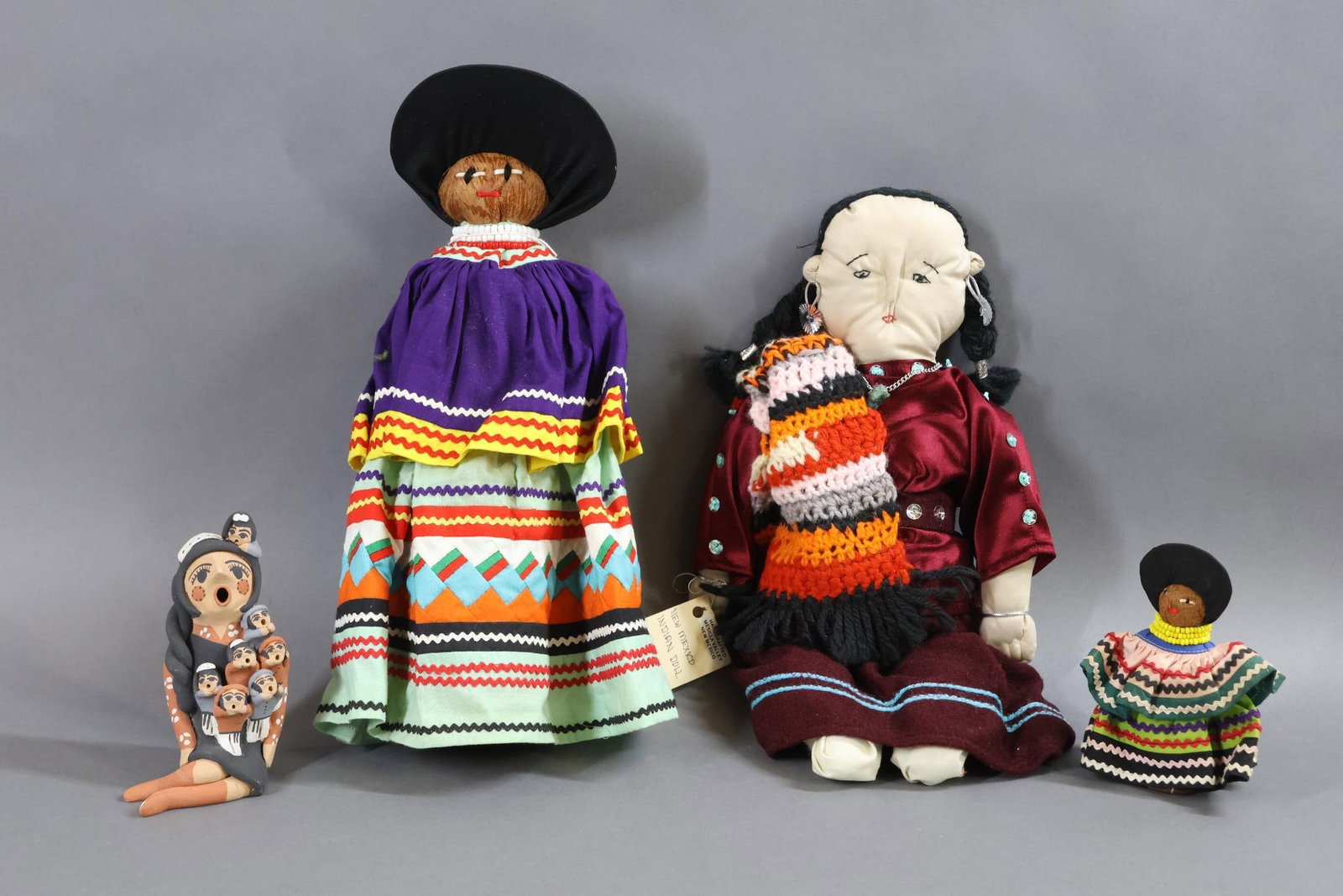 NATIVE AMERICAN DOLLS.: LOT of (4) dolls. Cloth - 14" tagged "New Mexico Indian Doll". Handcrafted Mesilla Valley, New Mexico. Palm - 13" Tagged "Osceola" doll by artist Mrs. Jimmy. Seminole. Arts and Crafts 4 1/2" Unmarked 