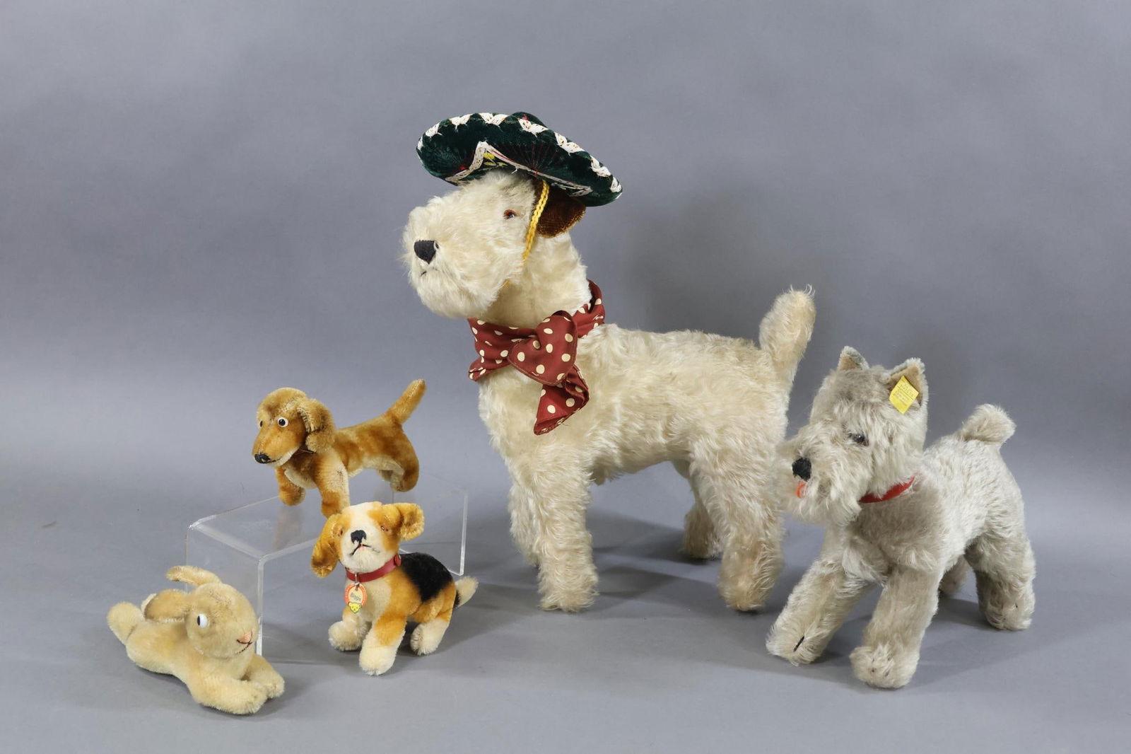 VINTAGE STEIFF/OTHER.: LOT of (4) STEIFF mohair animals and other mohair animal. STEIFF - 9" T. Grey "Tessie" Schnauzer with swivel neck. Brown glass eyes. Original red collar with tag. Tag back reads EULAN BAYER. Incised s