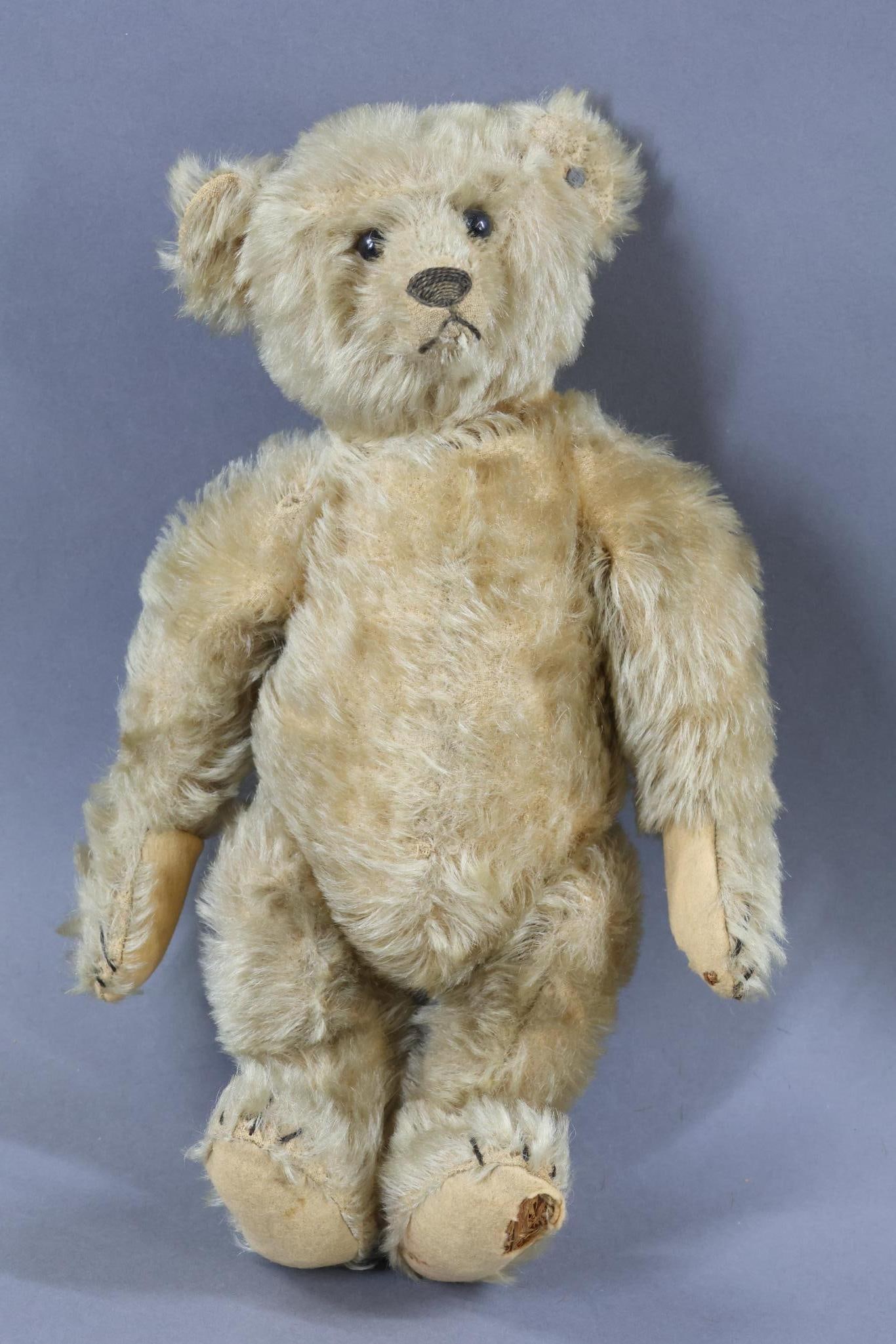 VINTAGE STEIFF.: Original family owned Bear. 13" Pre-1924 Camel mohair "Original Teddybar". Swivel neck, black shoe button eyes. Elongated nose. Camel felt pads. Raised silver button with the second "F" in Steiff wrap