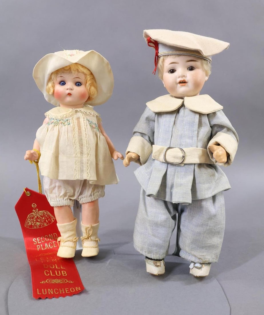 BISQUE DOLLS 12"/UNDER.: Pair of GERMAN character dolls. Both dolls have sleep eyes, blonde mohair wigs, 5 Pc. papier mache toddler bodies. Doll 1) 9" Painted bisque all original "Just Me" doll marked A.310/7/0.M. Blue eyes, 