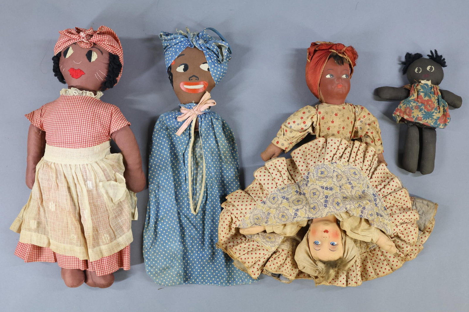 BLACK DOLLS.: LOT of (4) vintage/antique cloth dolls. 8" Doll tagged (very faint) Miami, FLA? Painted features, wool yarn hair. 16" 1930's Laundry Bag with painted features. Clothing for head is a cloth bag tied to
