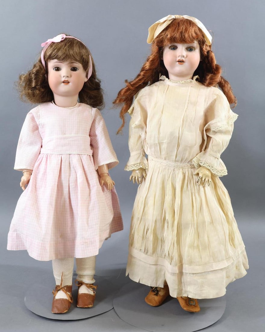 GERMAN BISQUE DOLLS.: Pair of museum deaccession dolls. Both dolls have sleep eyes, open mouths, papier mache ball jointed bodies, and are dressed in vintage/antique outfits. Doll 1) 22" SIMON & HALBIG GB with brown eyes, 