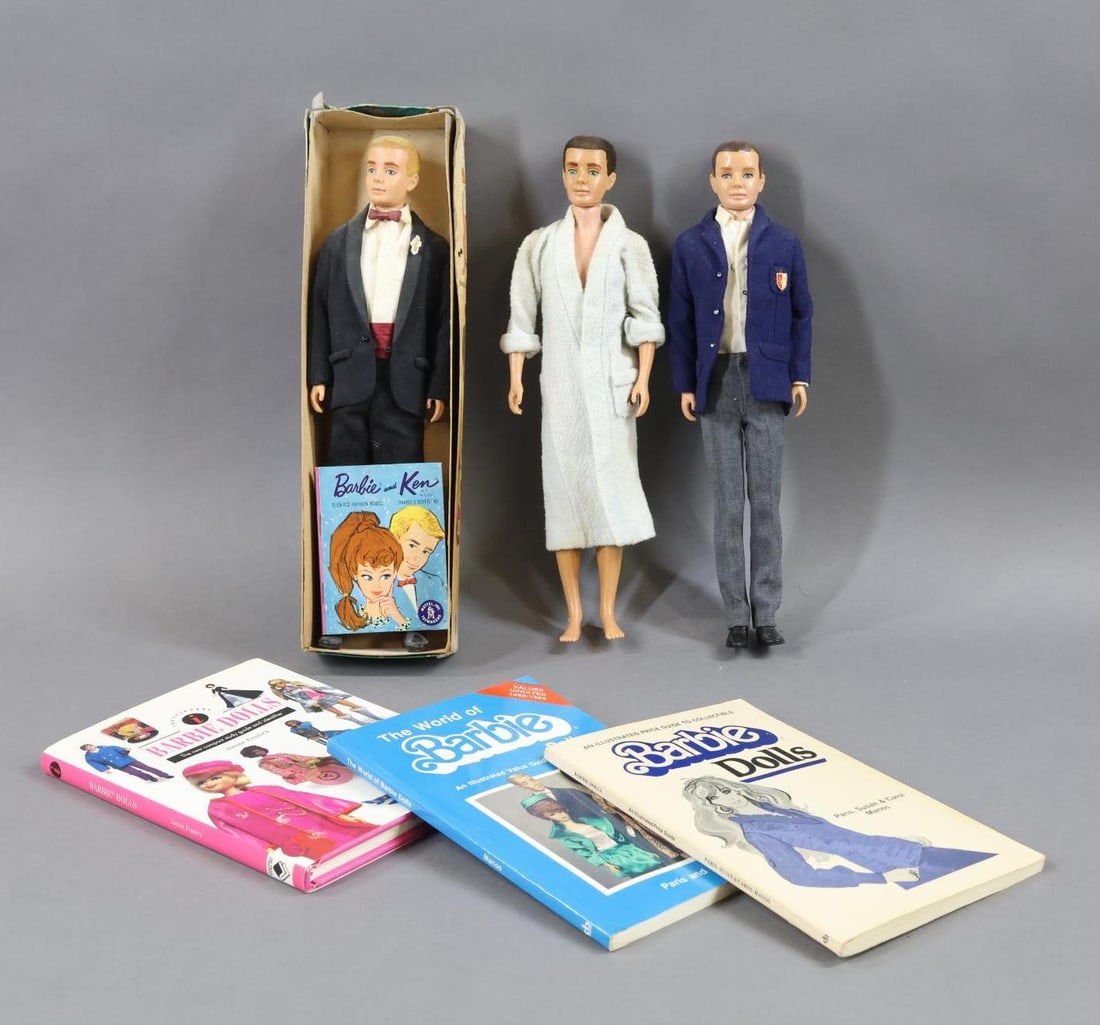 VINTAGE BARBIE FAMILY.: LOT of KEN. (3) Dolls, books. (2) Flocked hair dolls. 1961 Blonde No. 750 in OB. Dressed in tuxedo, shoes. BARBIE and KEN booklet. (Hair is worn, box has discoloration, no stand.) Doll with black floc