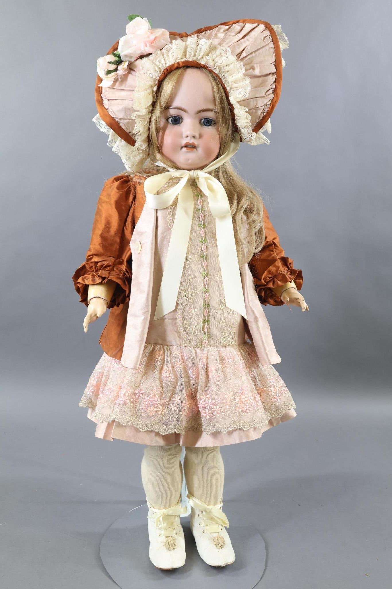 GERMAN BISQUE DOLLS.: 27" SH 1079 - 13 1/2 DEP doll with blue sleep eyes, open mouth, pierced ears, long honey blonde HH wig. Papier mache ball jointed body. Dressed in beautiful custom made silk outfit - French style pink