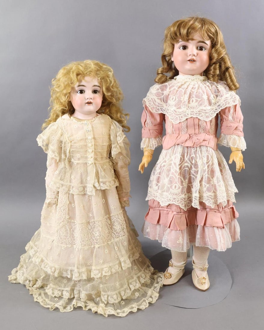 GERMAN BISQUE DOLLS.: Pair of KESTNER dolls. Both dolls have brown sleep eyes, open mouths. Doll 1) 22" 11 DEP 154 Shoulder head doll with long curly honey blonde mohair wig, plaster pate. Leather pin jointed body with bis