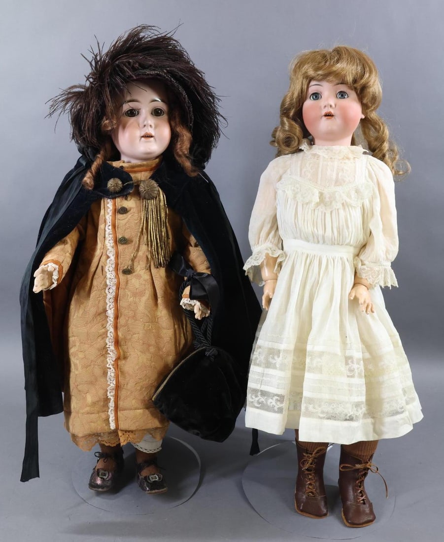 GERMAN BISQUE DOLLS.: Pair of dolls. Both dolls have sleep eyes, open mouths, papier mache ball jointed bodies. Doll 1) 27" K * R SIMON & HALBIG 403 doll with blue eyes, honey blonde curly HH wig. Dressed in antique white 