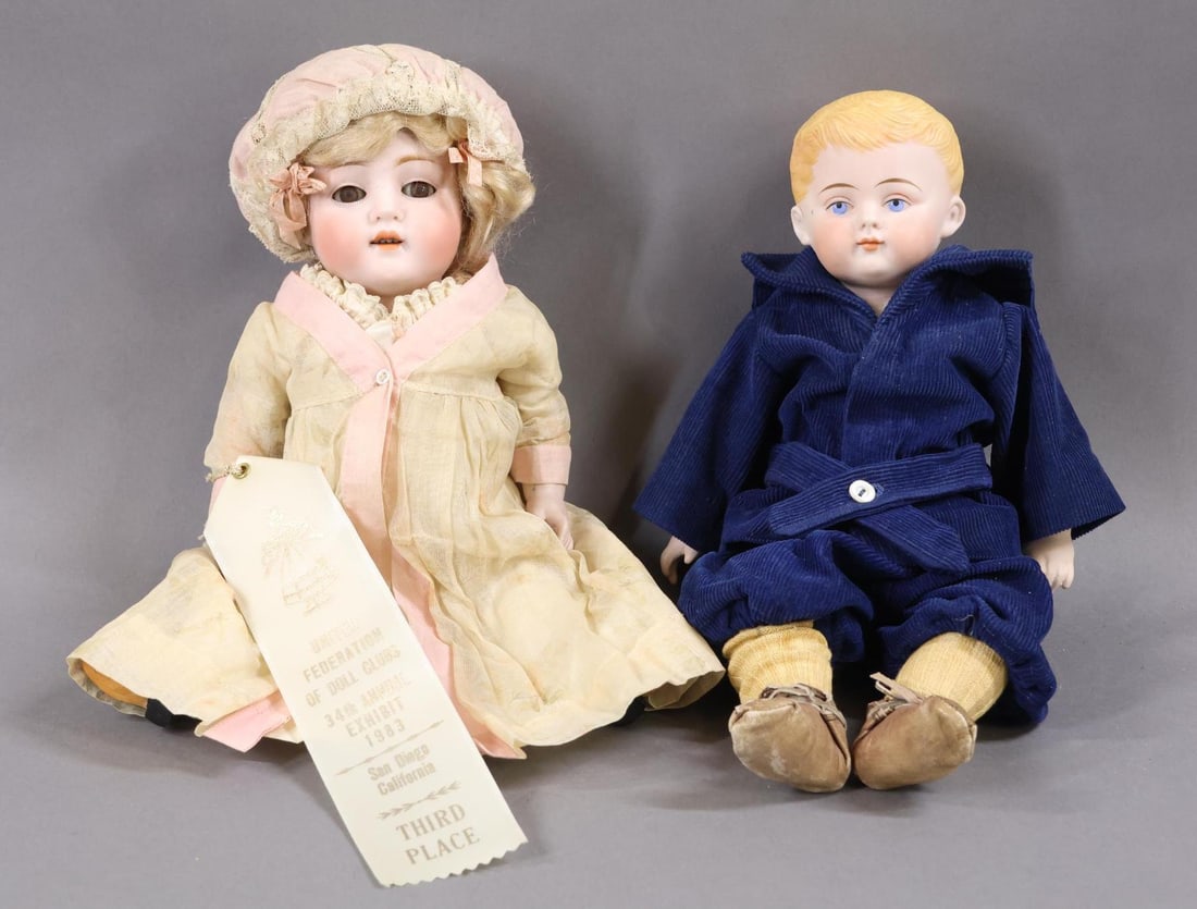 ALL BISQUE.: Pair of dolls. Doll 1) 12" 150.7 Character doll with brown sleep eyes, open mouth, blonde curly mohair wig, plaster pate. 5 Pc. body with painted/molded black 1-strap shoes, pink shirred socks. Dresse