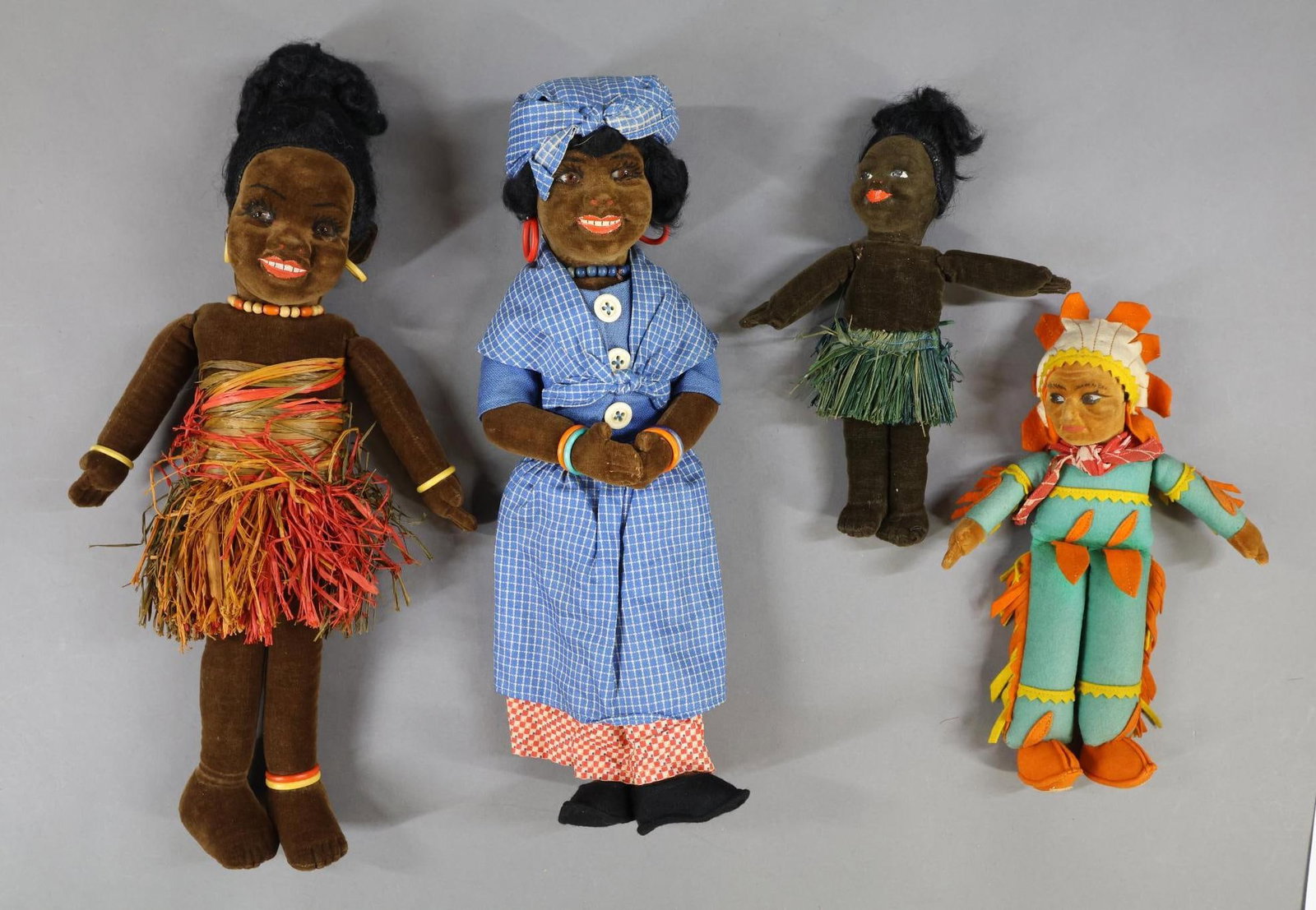 BLACK/NATIVE AMERICAN DOLLS.: LOT of (4) NORAH WELLINGS Dolls. (3) Black dolls - (2) glass eyed dolls. 15" Island Lady doll and 13 1/2" Lady doll. Painted eye - 8 1/2" Island doll. Native American - 10" Painted eye doll. Condition