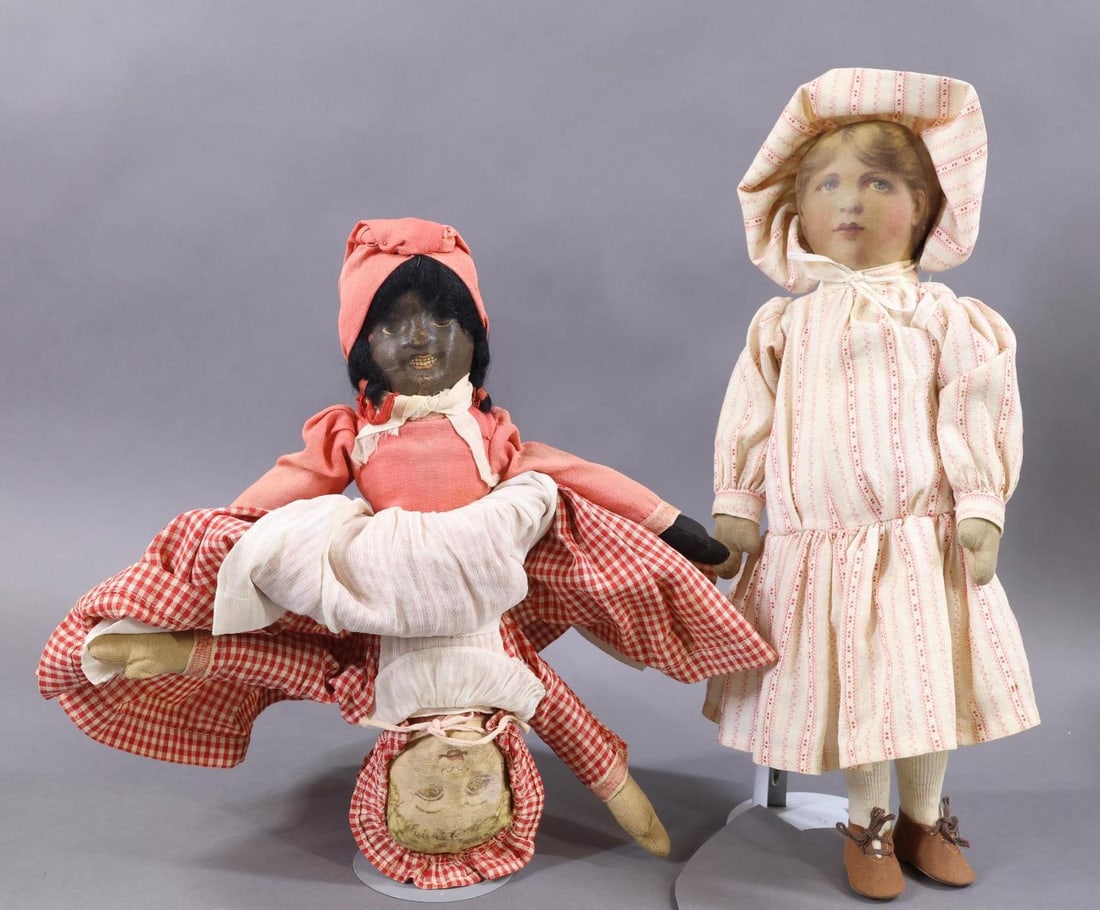CLOTH DOLLS.: Pair of dolls. 14" "Babyland Rag" doll with printed face. Vintage clothing, brown oilcloth shoes. 11" "Bruckner" Topsy-Turvy doll with Black and White faces. Antique clothing. Condition: the Black fac