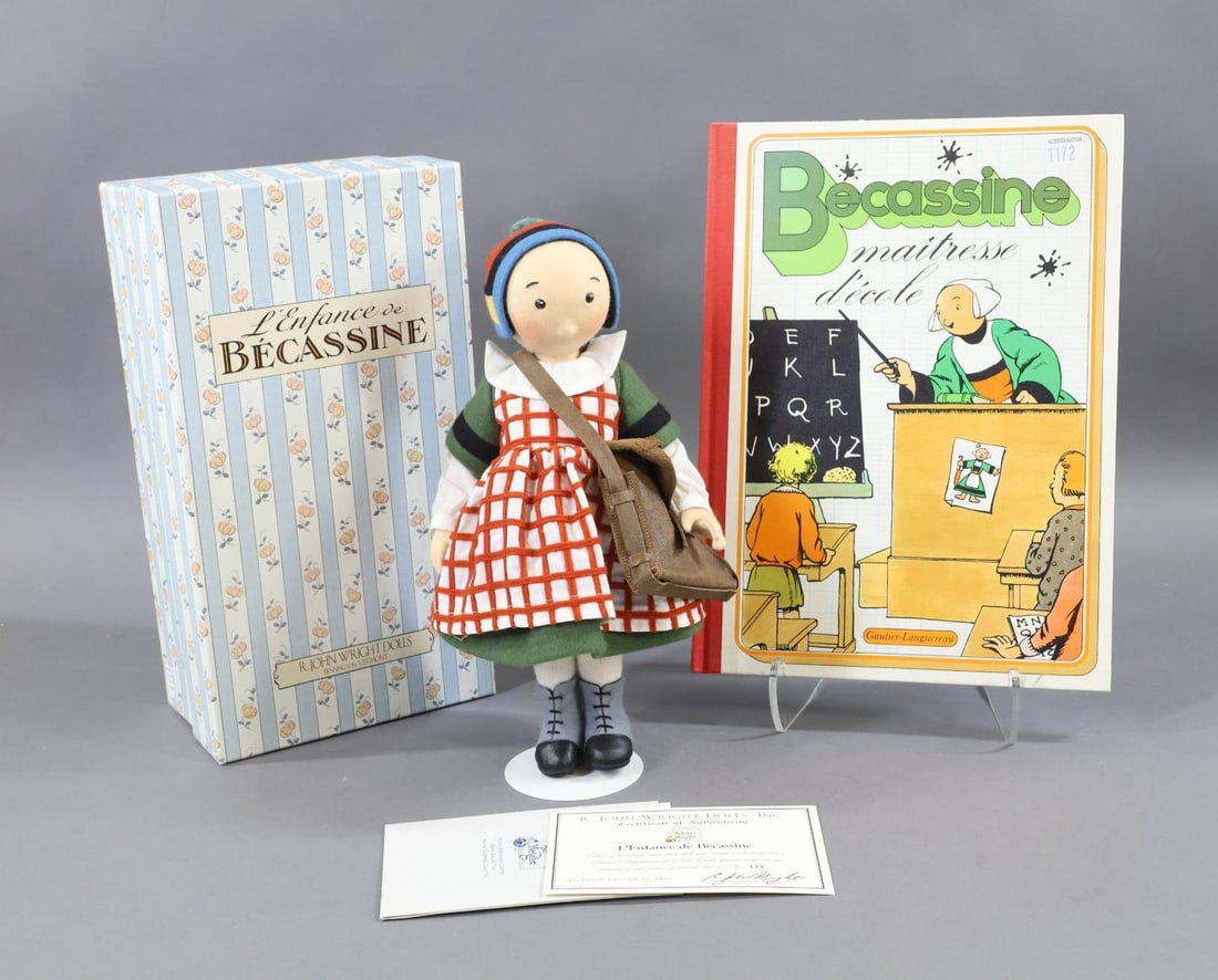 R. JOHN WRIGHT.: MIB 11 1/2" "L'Enfance de Becassine" Doll in OB. This was made Exclusively for a UFDC Special Event in an Edition of 400 pcs. No. 177/400. COA. Stand. This lot is being sold AS IS. Also comes with the