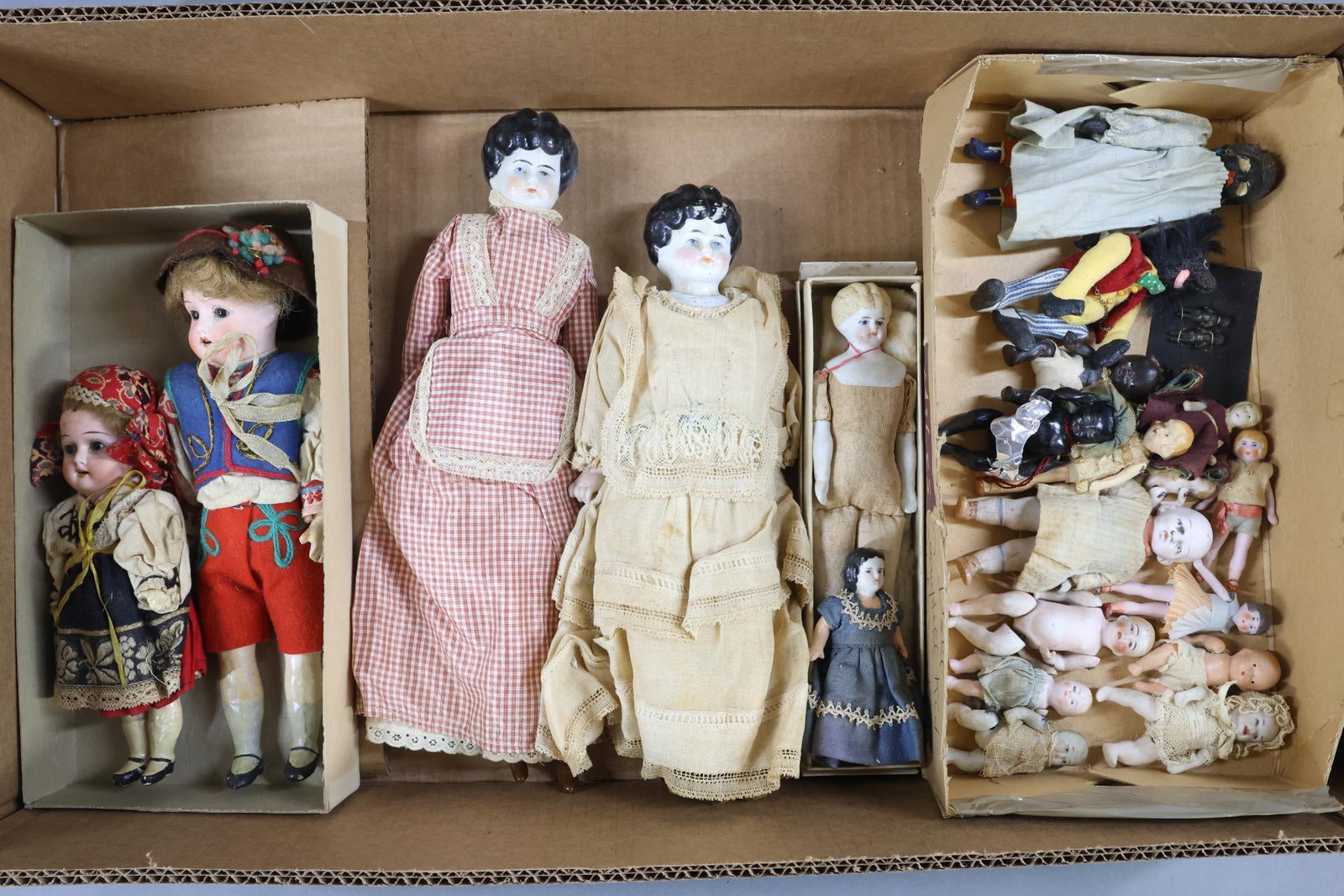 GERMAN BISQUE, CHINA, OTHER DOLLS.: Large LOT of dolls. Dolls 12" Under - pair of bisque dolls with stationary brown eyes, open mouths, brown mohair wigs, 5 pc. papier mache bodies. Painted shoes, original clothing - 7" HEUBACH KOPPELSD
