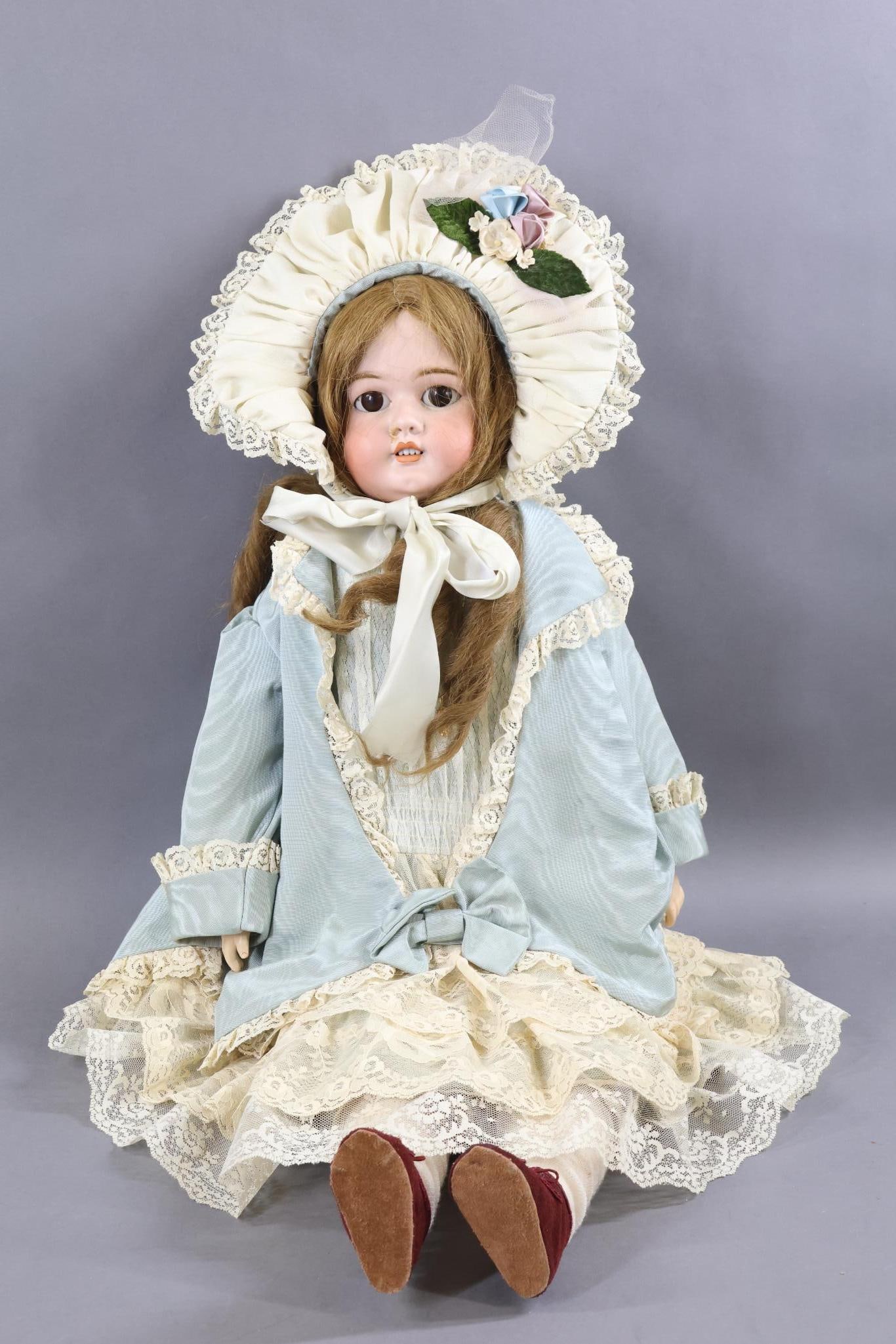 GERMAN BISQUE DOLLS.: 30" GERMANY HEINRICH HANDWERCK Shoulder Head Doll with slightly turned head. Brown sleep eyes, open mouth, pierced ears, long curly brown HH wig. Pale pink leather gusseted body with papier mache lowe