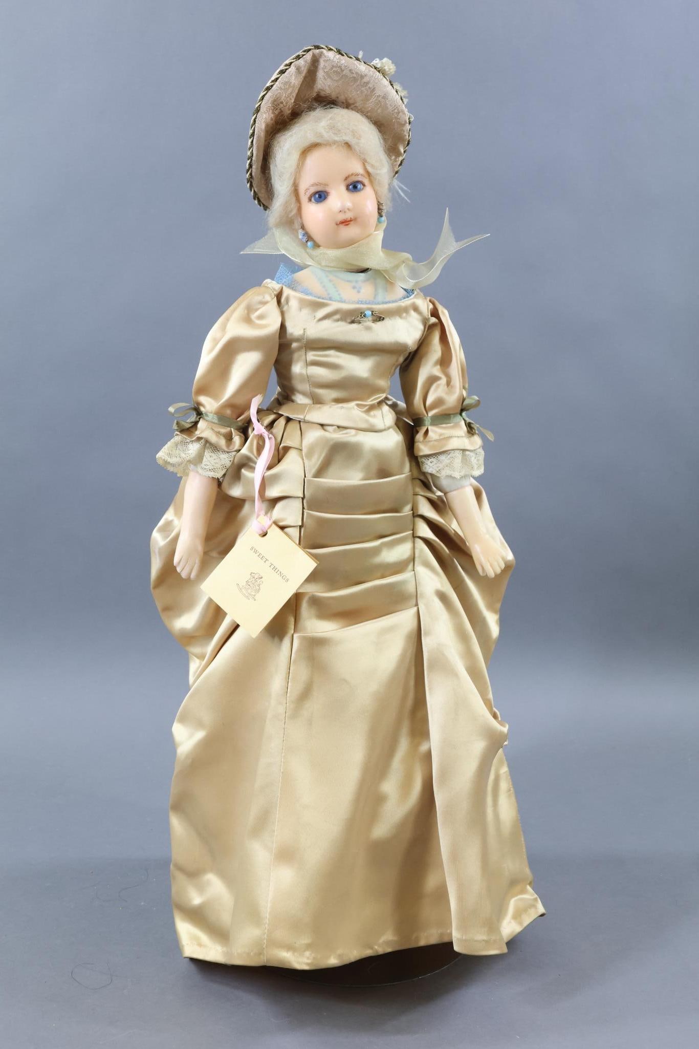 WAX ARTIST DOLL.: 23" "Melanie", Lady wax over composition doll, 1860-1900. Socket head mounted on a decorated wax over shoulder plate. Stationary blue eyes, closed mouth, pierced ears, blonde mohair wig. Cloth body wi