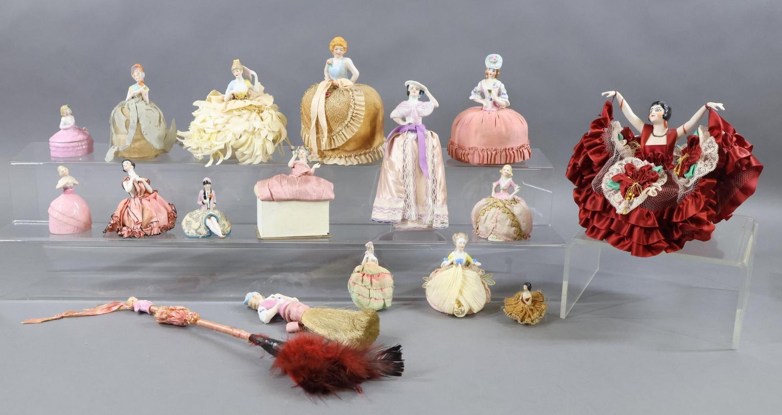 CHINA, PARIAN DOLLS.: LOT of China half Dolls and dressing table novelties. German and Japanese. (11) Actual Half Dolls. These are all mounted on pin cushions, (1) on a small cardboard box. (2) Are mounted on powder puffs.