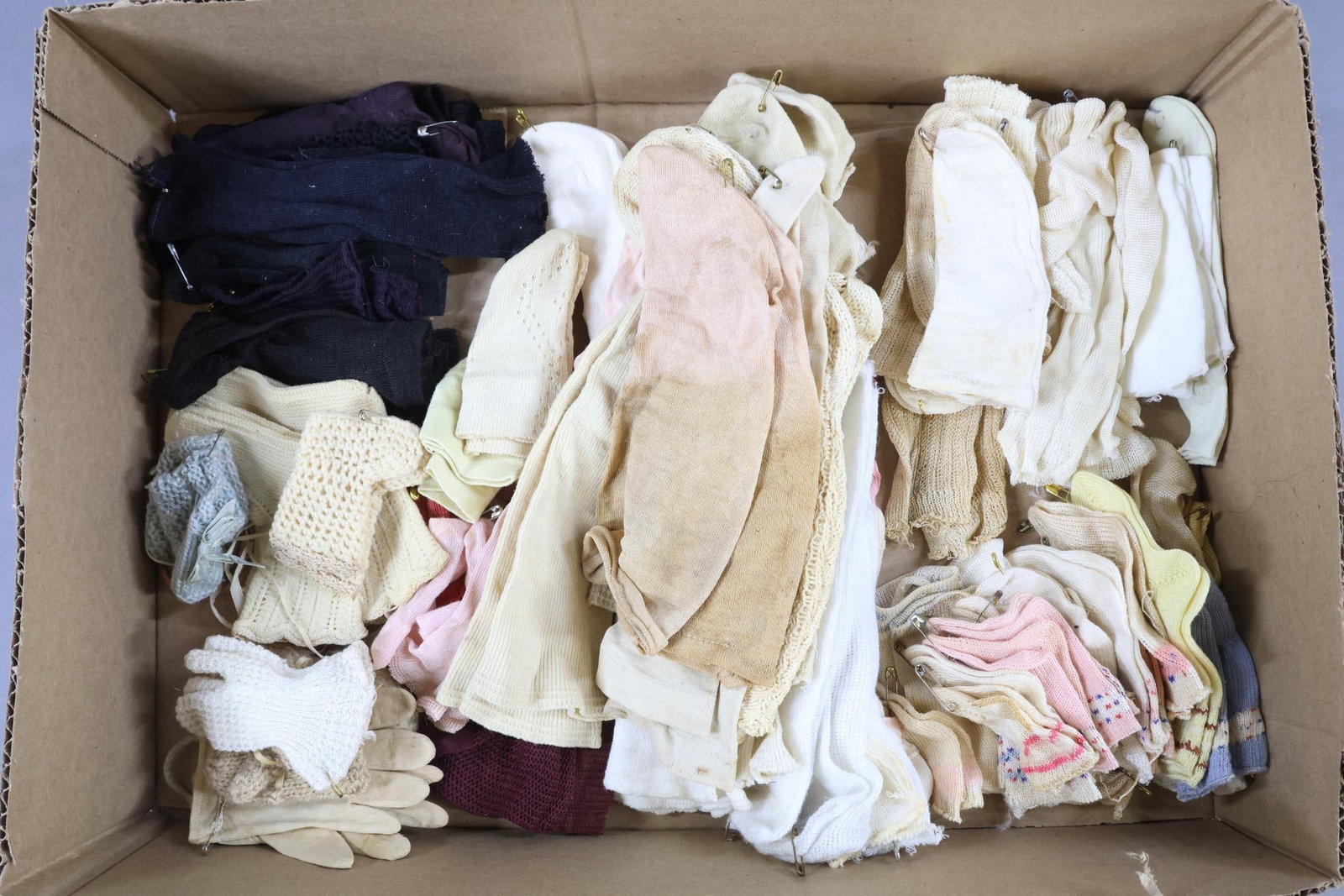 ACCESSORIES, SUPPLIES.: LOT. 50+ Prs. of doll socks - cotton, wool, rayon, nylon, Dol-Sox. 3" -11" . 4 Prs. Booties. 4 Prs. Gloves/mittens. Condition: age discoloration, loss. This lot is being sold AS IS.