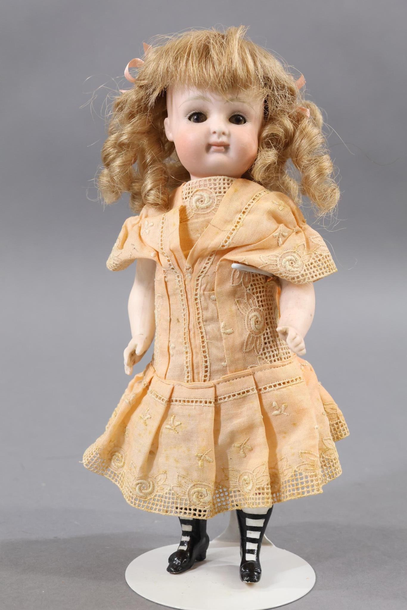 GERMAN ALL BISQUE DOLLS.: 8" III (KESTNER) early Pouty Doll. This is an original family owned doll. Brown sleep eyes, closed mouth, curly honey blonde French HH wig. Swivel neck, 5 pc. body with painted black bootines, white s
