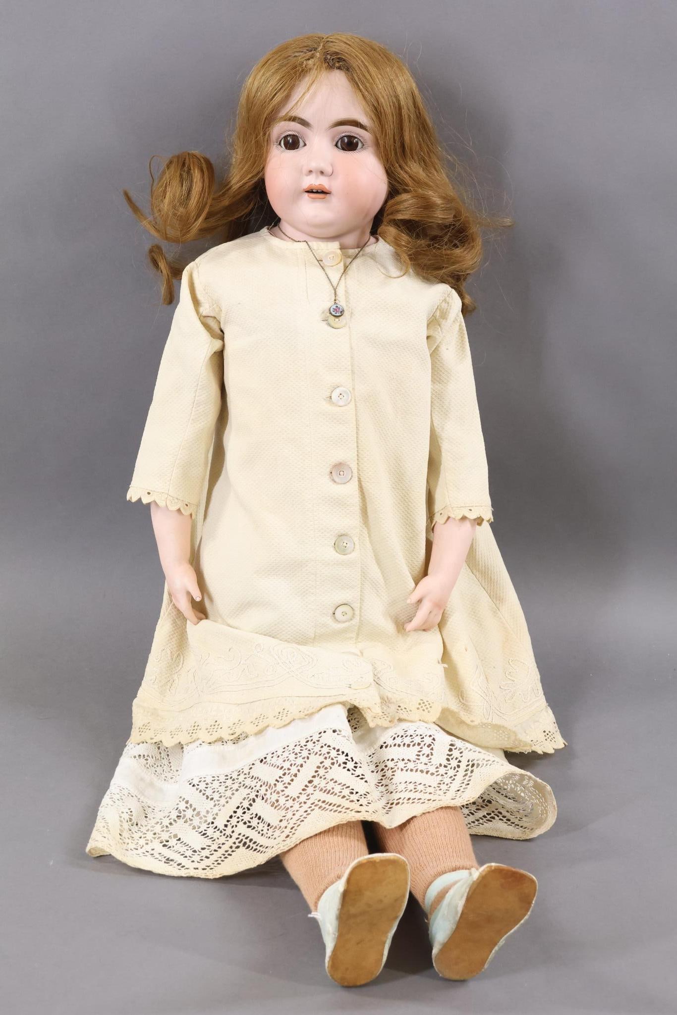 GERMAN BISQUE DOLLS.: 32" KESTNER (mark is covered by leather body) Turned shoulder head doll with brown sleep eyes, open mouth, brown HH wig. PINK leather pin jointed body. Bisque lower arms. Dressed in antique ivory cott