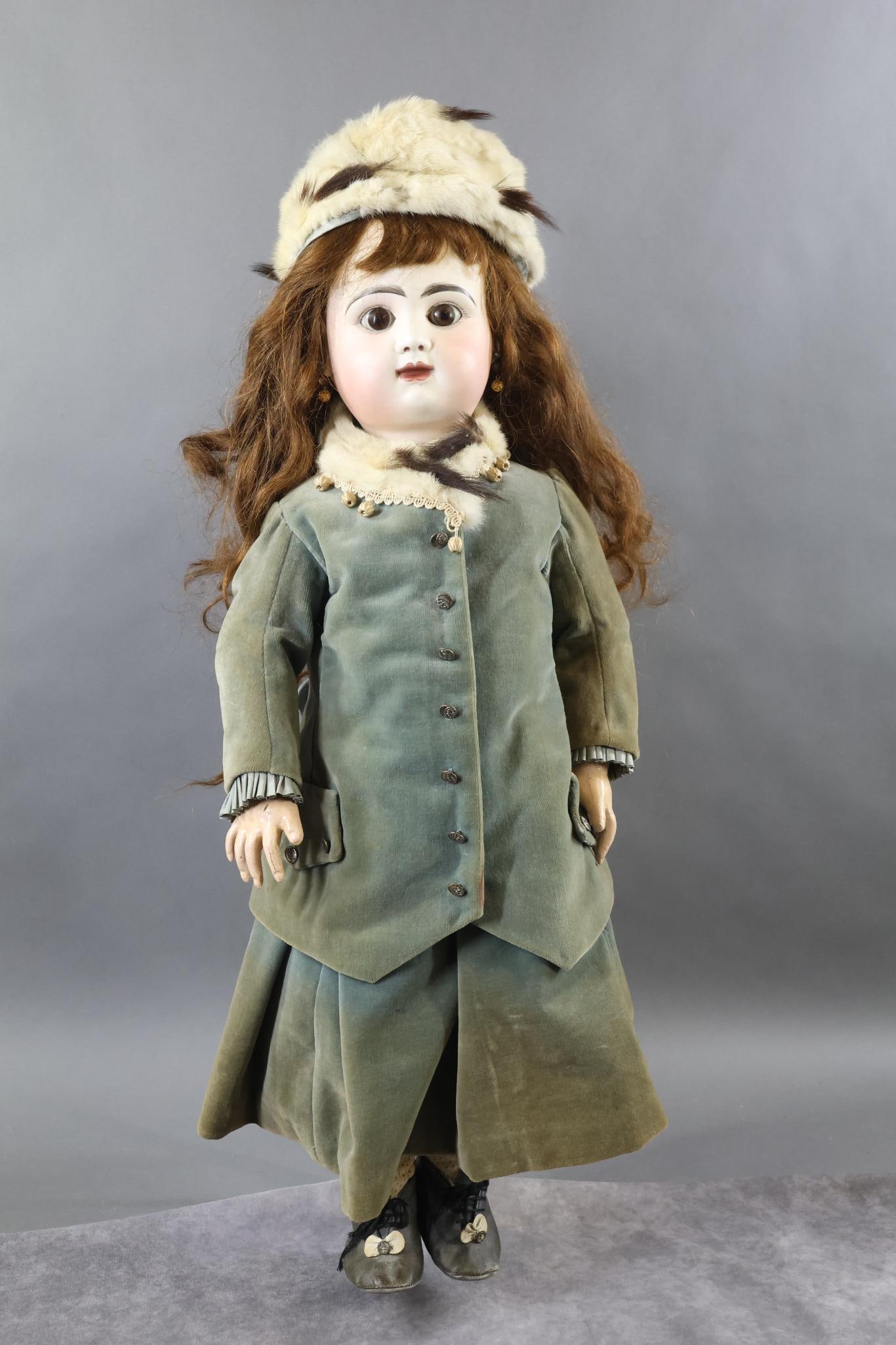 FRENCH BISQUE DOLLS.: 28 1/2" R.4.D. Doll with stationary brown eyes, closed mouth, pierced ears, very long brown HH wig. Unmarked papier mache French body with separate hands. Dressed in vintage green velveteen 2 pc. outf