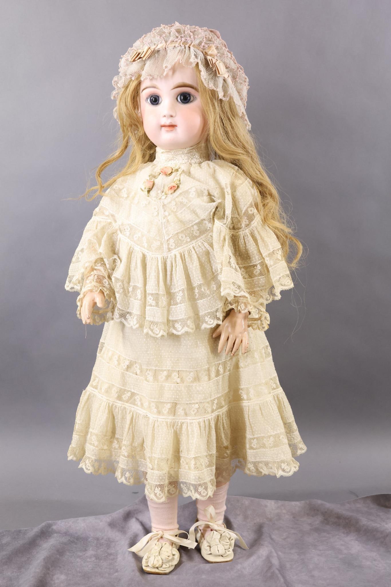 FRENCH BISQUE DOLLS.: 30" BEBE MASCOTTE (Marked MASCOTTE M). Blue paperweight eyes, closed mouth, pierced ears, long honey blonde HH wig, wood pate. French papier mache, wood jointed body with separate hands. Dressed in be