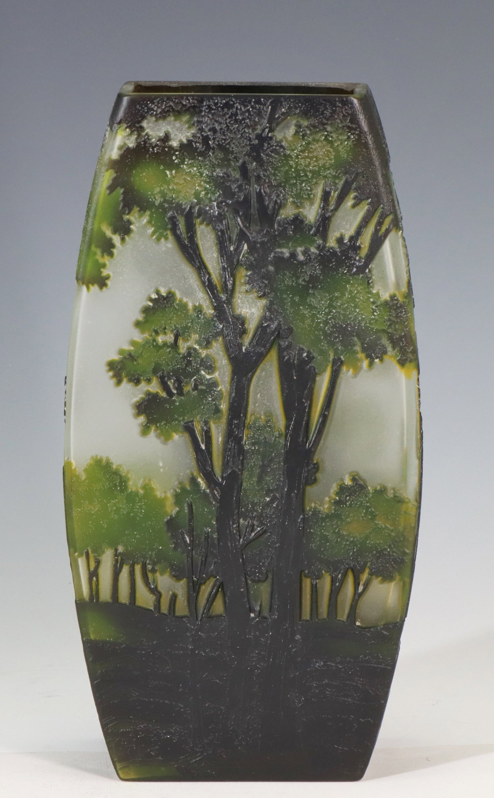 Cameo Glass Vase: 20th-century cameo glass vase with an acid-etched forest landscape. The vase has a squared, tapering form and polished pontil. Marked on the base. There is a chip to the overlay glass on one side. 10"