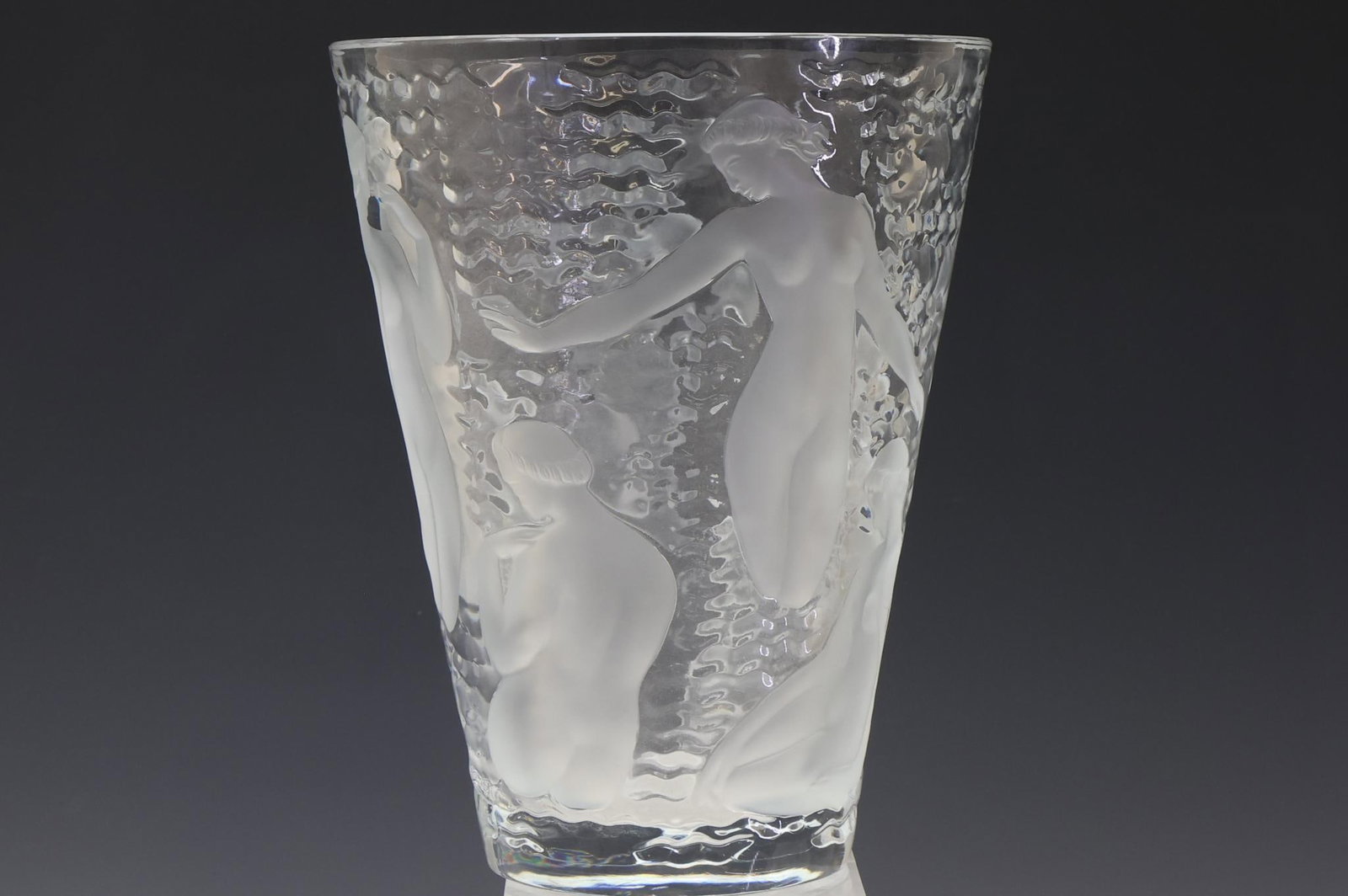 Lalique Ondines Crystal Vase: French molded crystal vase, frosted nudes in relief over textured clear glass, with engraved markings. 9.5"h x 7.5"w