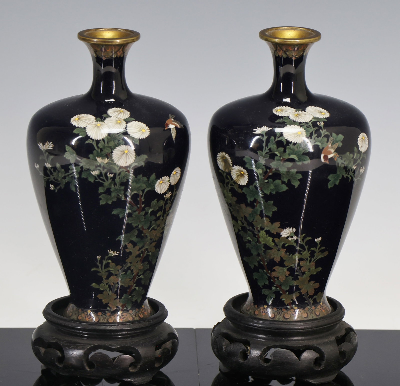 Ando Jubei Japanese Cloisonne Vases: Meiji - Showa era silver wire cloisonne pair of vases decorated with sparrows and chrysanthemums on a black ground, with stylized floral borders. Marked for Ando Jubei (1876-1953) to the foot. Include
