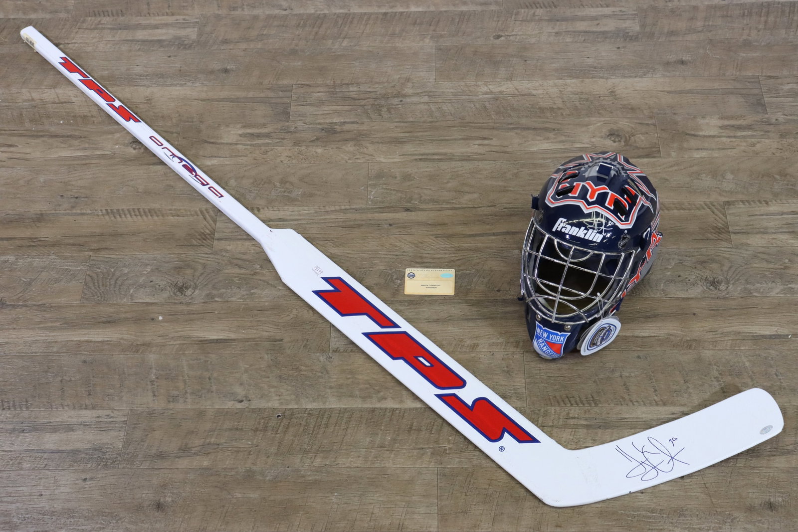 Henrik Lundquist Autographed Hockey Sick & Mask: This lot features an autographed Henrik Lundqvist goalie stick and goalie mask, both authenticated by a Steiner hologram and accompanied by an official certificate of authenticity. The stick, a TPS-br