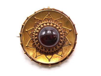 14k YG Garnet Brooch: Victorian 14k gold brooch with a 13mm cabochon garnet at center, Etruscan Revival wirework and bead detailing, and a hair memorial compartment on the reverse. 1.25" and 7.3dwt