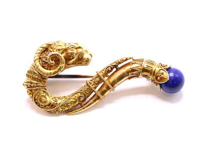 Victorian Brooch: Victorian Etruscan revival brooch with a detailed ram’s head with scrolling filigree ending in a lapis lazuli bead. Gold filled. 2"