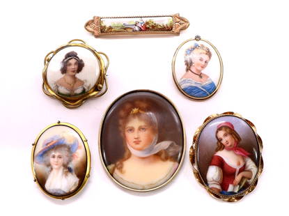 Painted Porcelain Pins: Collection of (5) painted porcelain portrait pins and (1) painted bar pin. All in gold filled frames. Largest 2.5"h x 2"w